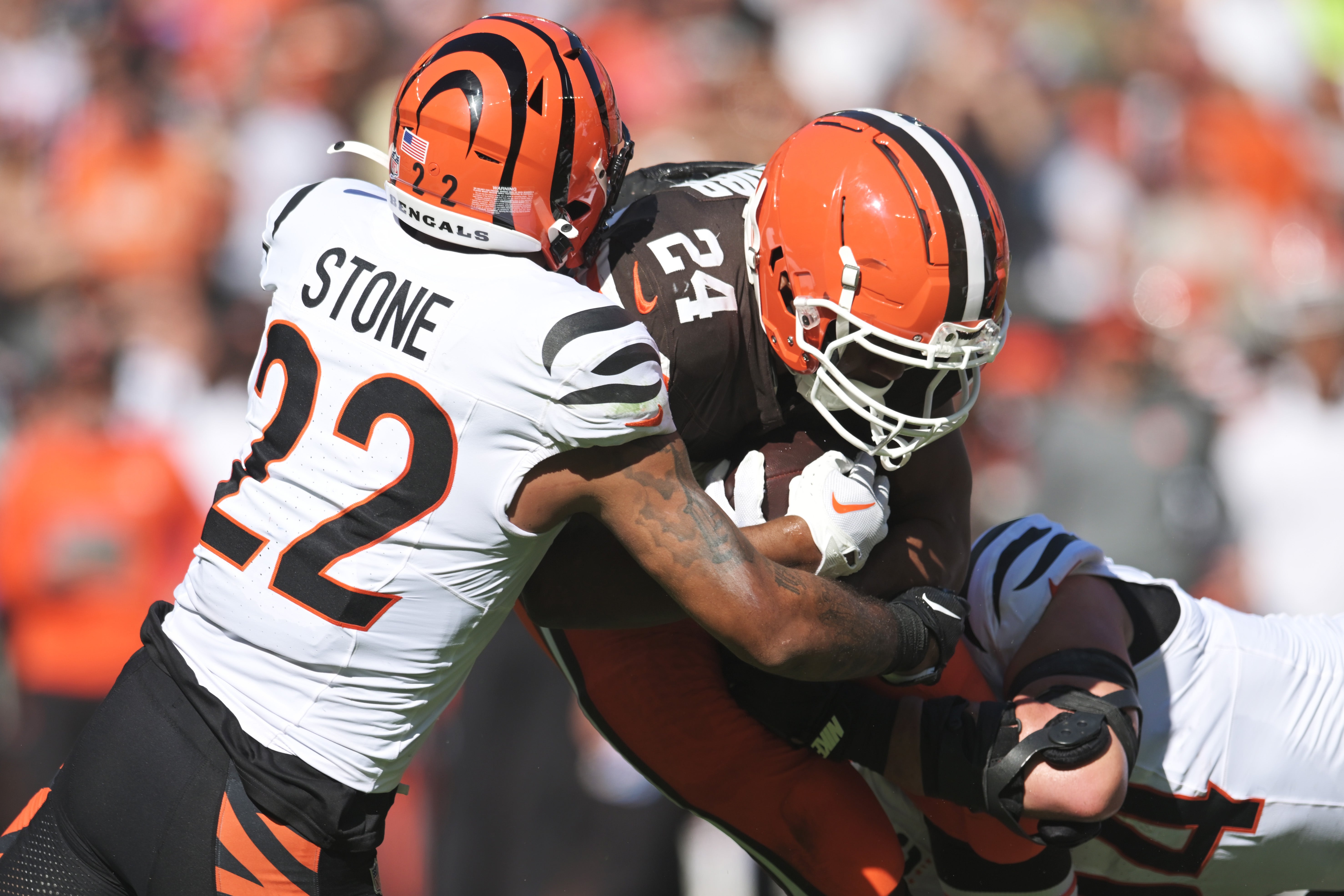Oct 20, 2024; Cleveland, Ohio, USA; Cincinnati Bengals safety Geno Stone (22) tackles Cleveland Browns running back Nick Chubb (24) during the first half at Huntington Bank Field.