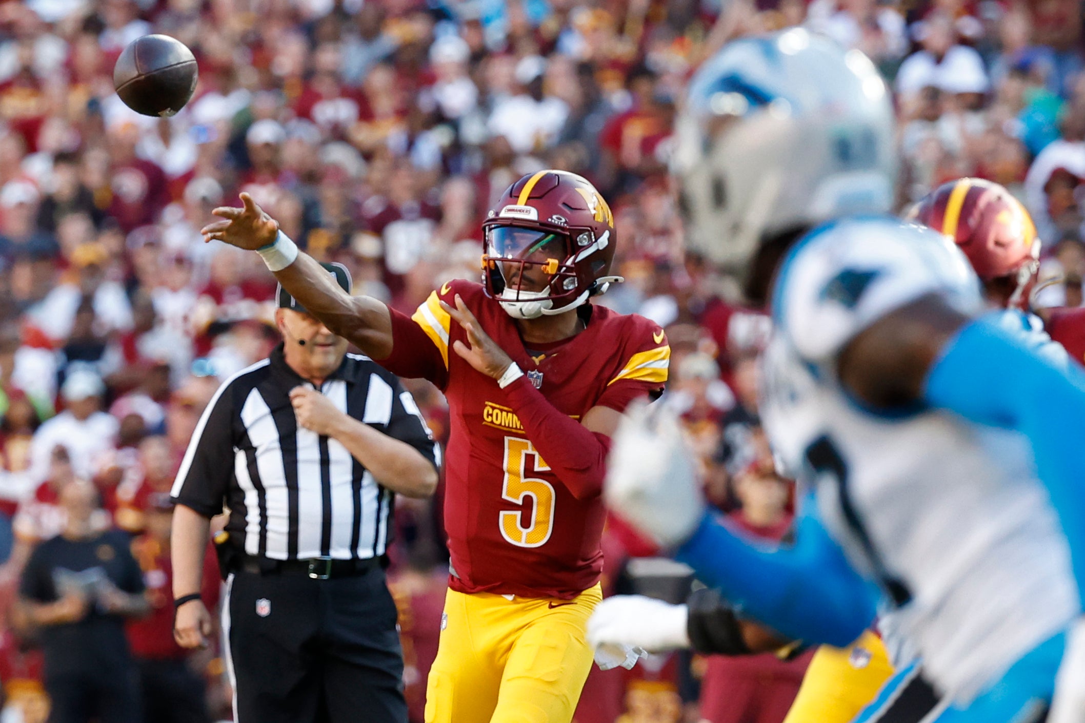 Oct 20, 2024; Landover, Maryland, USA; Washington Commanders quarterback Jayden Daniels (5) passes the ball against the Carolina Panthers during the first quarter at Northwest Stadium.