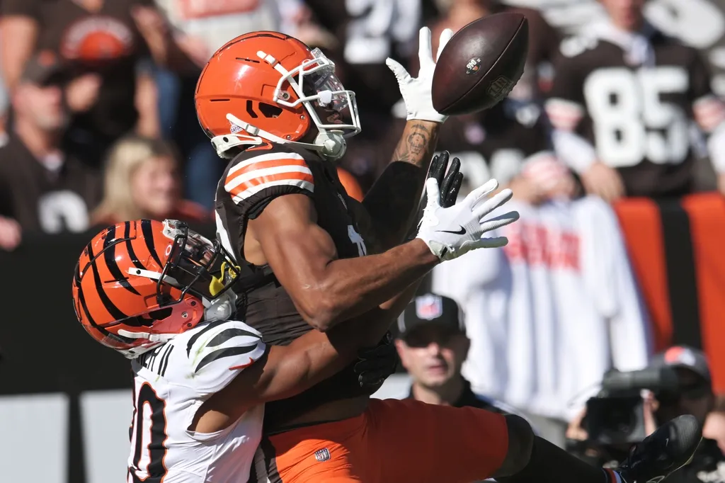 Cincinnati Bengals cornerback DJ Turner II (20) interferes with Cleveland Browns wide receiver Cedric Tillman (19) on a pass play during the first half at Huntington Bank Field.