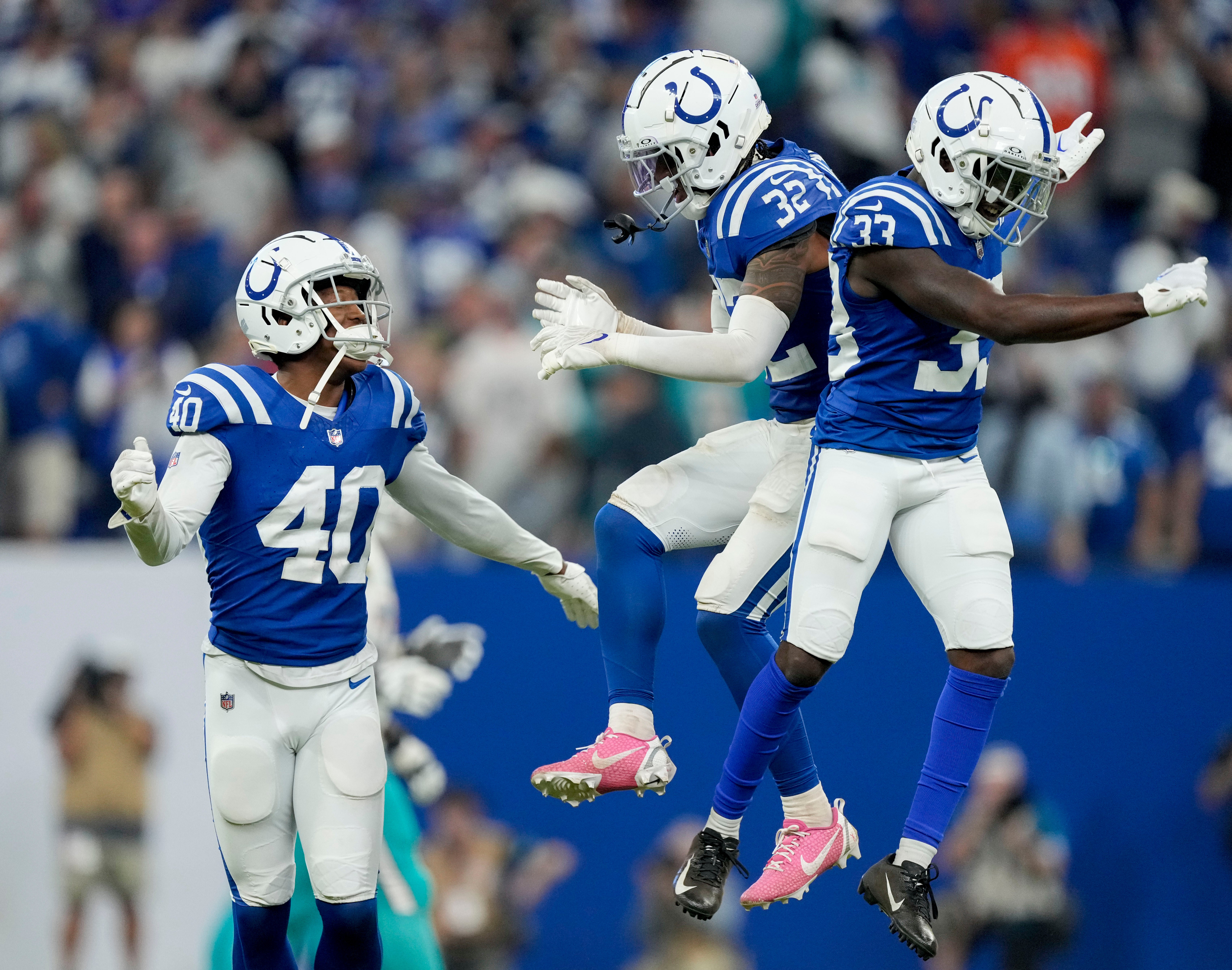 Oct 20, 2024; Indianapolis, Indiana, USA; Indianapolis Colts cornerback Jaylon Jones (40), Indianapolis Colts safety Julian Blackmon (32) and Indianapolis Colts cornerback Samuel Womack III (33) celebrate after stopping the Miami Dolphins on downs Sunday, Oct. 20, 2024, during a game against the Miami Dolphins at Lucas Oil Stadium.