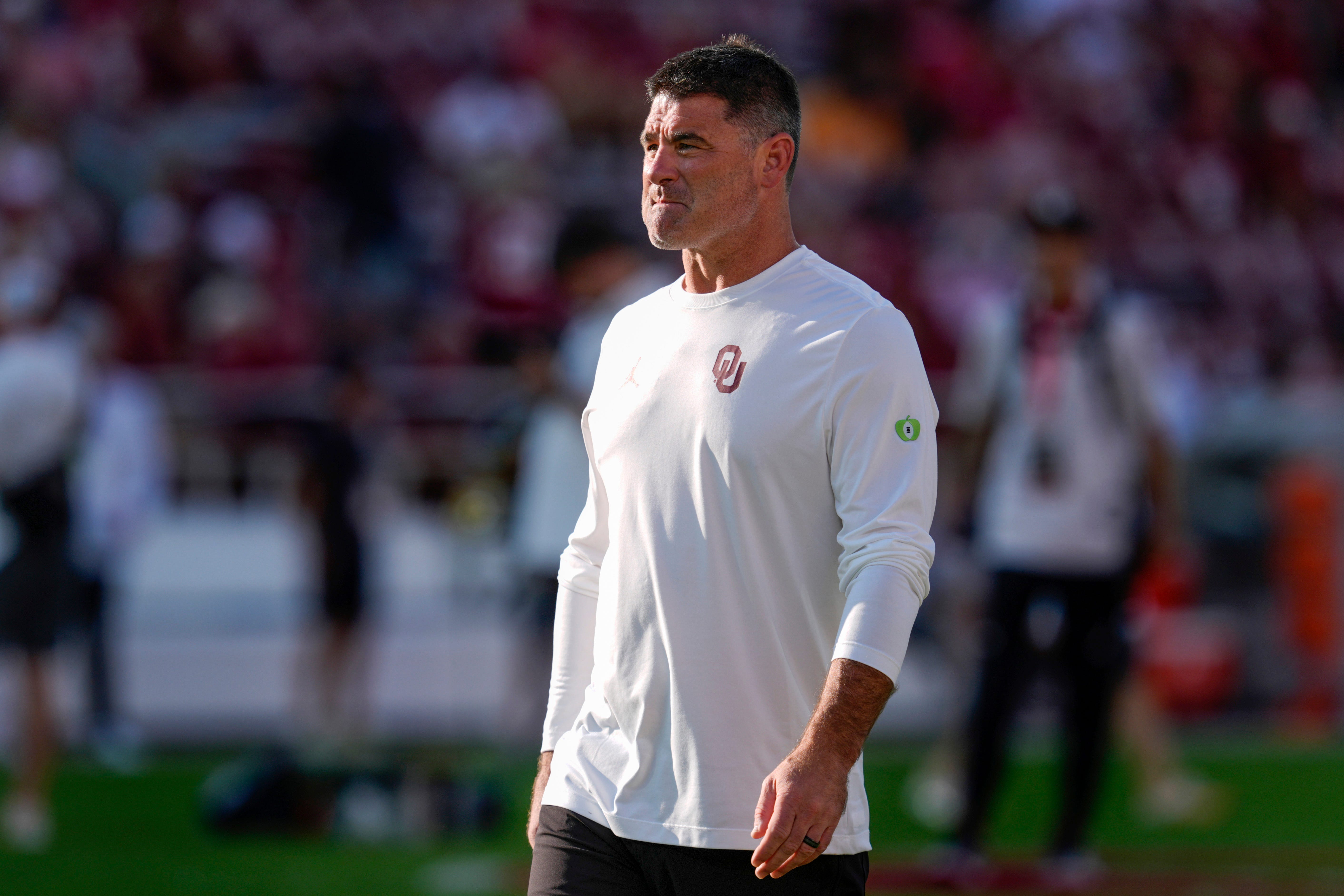 Oklahoma offensive coordinator Seth Littrell stands on the field before a college football game between the University of Oklahoma Sooners (OU) and the Tennessee Volunteers at Gaylord Family - Oklahoma Memorial Stadium in Norman, Okla., Saturday, Sept. 21, 2024.