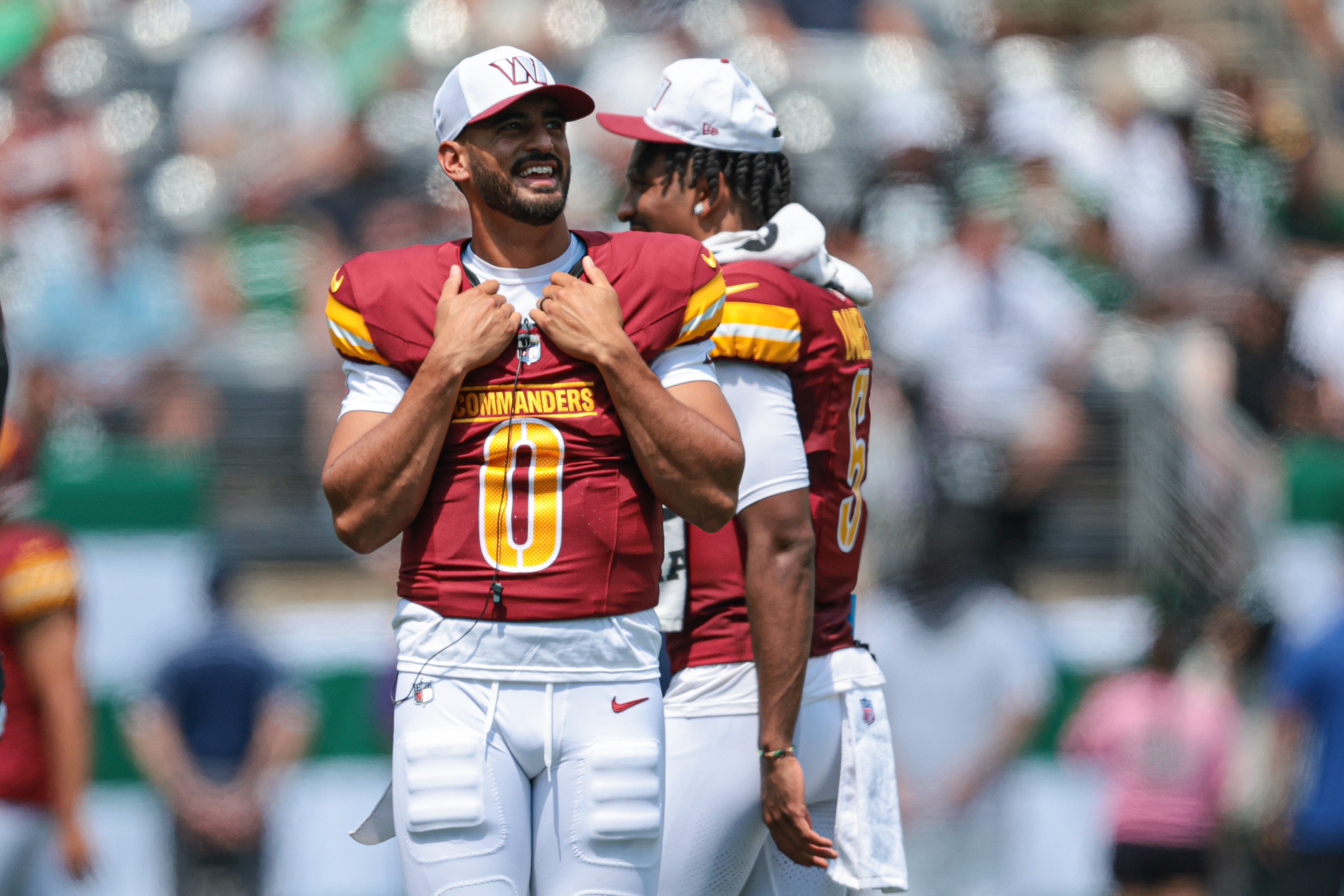 Aug 10, 2024; East Rutherford, New Jersey, USA; Washington Commanders quarterback Marcus Mariota (0) looks on during the first half against the New York Jets at MetLife Stadium.
