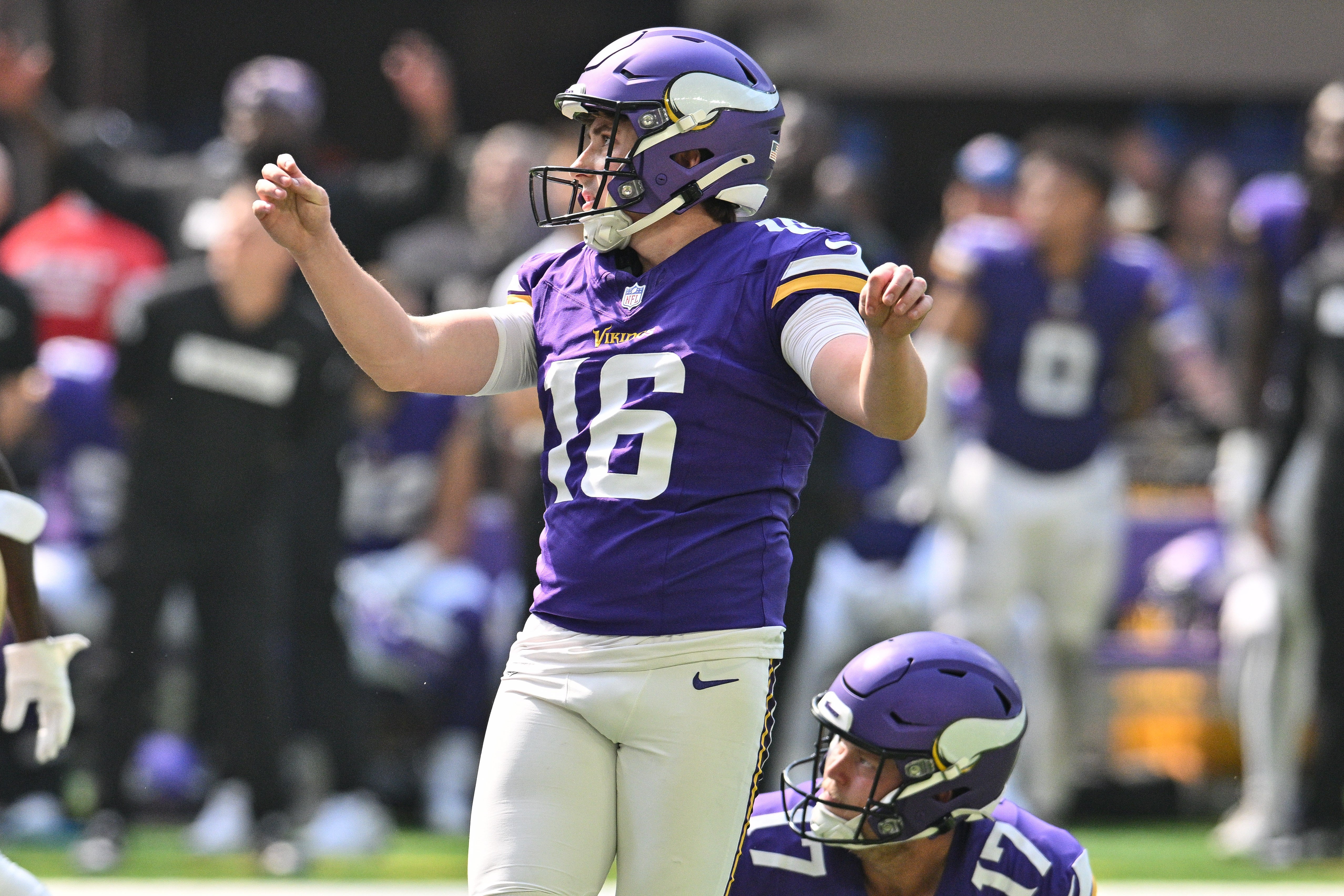 Sep 15, 2024; Minneapolis, Minnesota, USA; Minnesota Vikings place kicker Will Reichard (16) kicks a field goal as punter Ryan Wright (17) looks on during the second quarter against the San Francisco 49ers U.S. Bank Stadium.