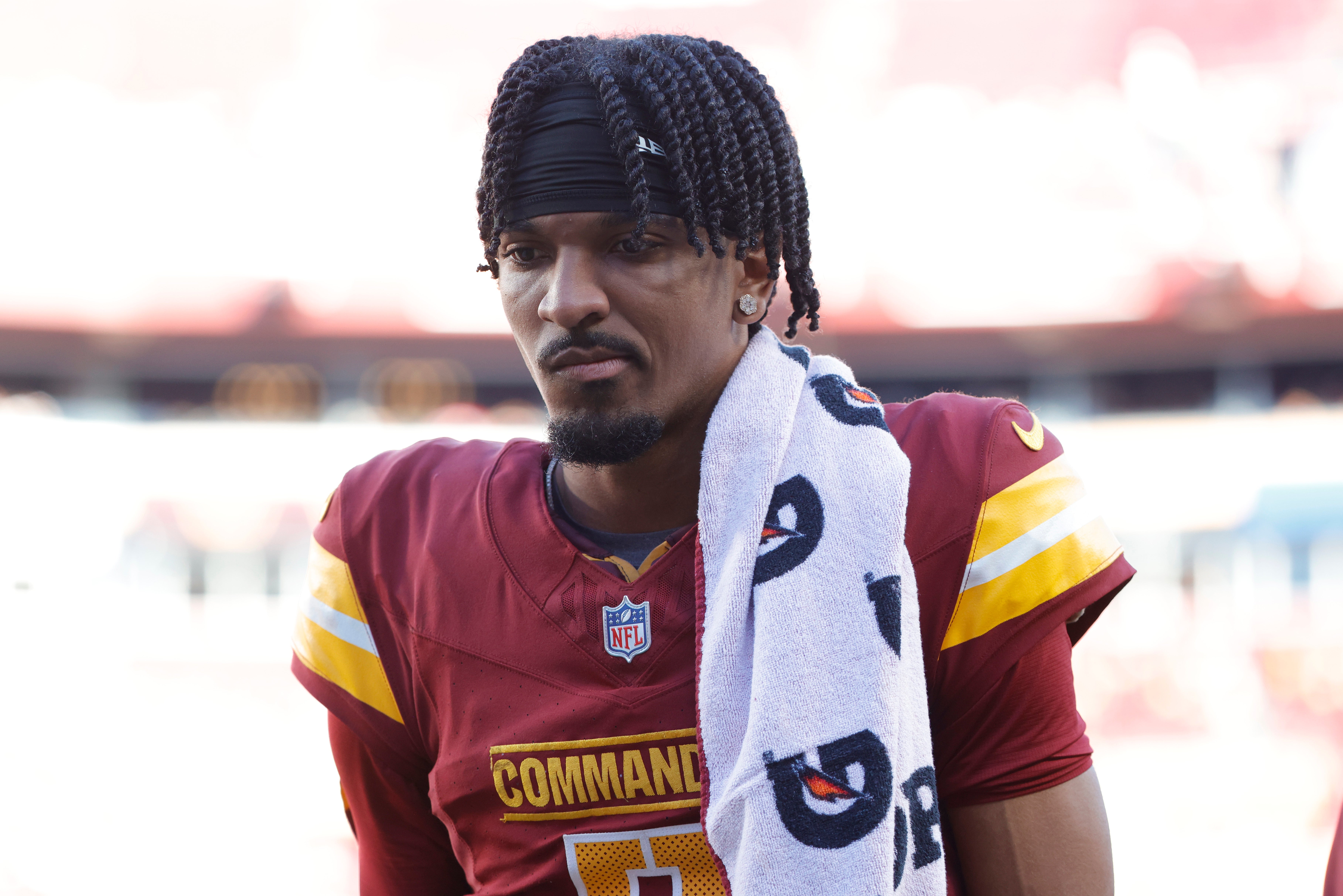 Oct 20, 2024; Landover, Maryland, USA; Washington Commanders quarterback Jayden Daniels (5) walks off the field during the first quarter after an injury against the Carolina Panthers at Northwest Stadium.