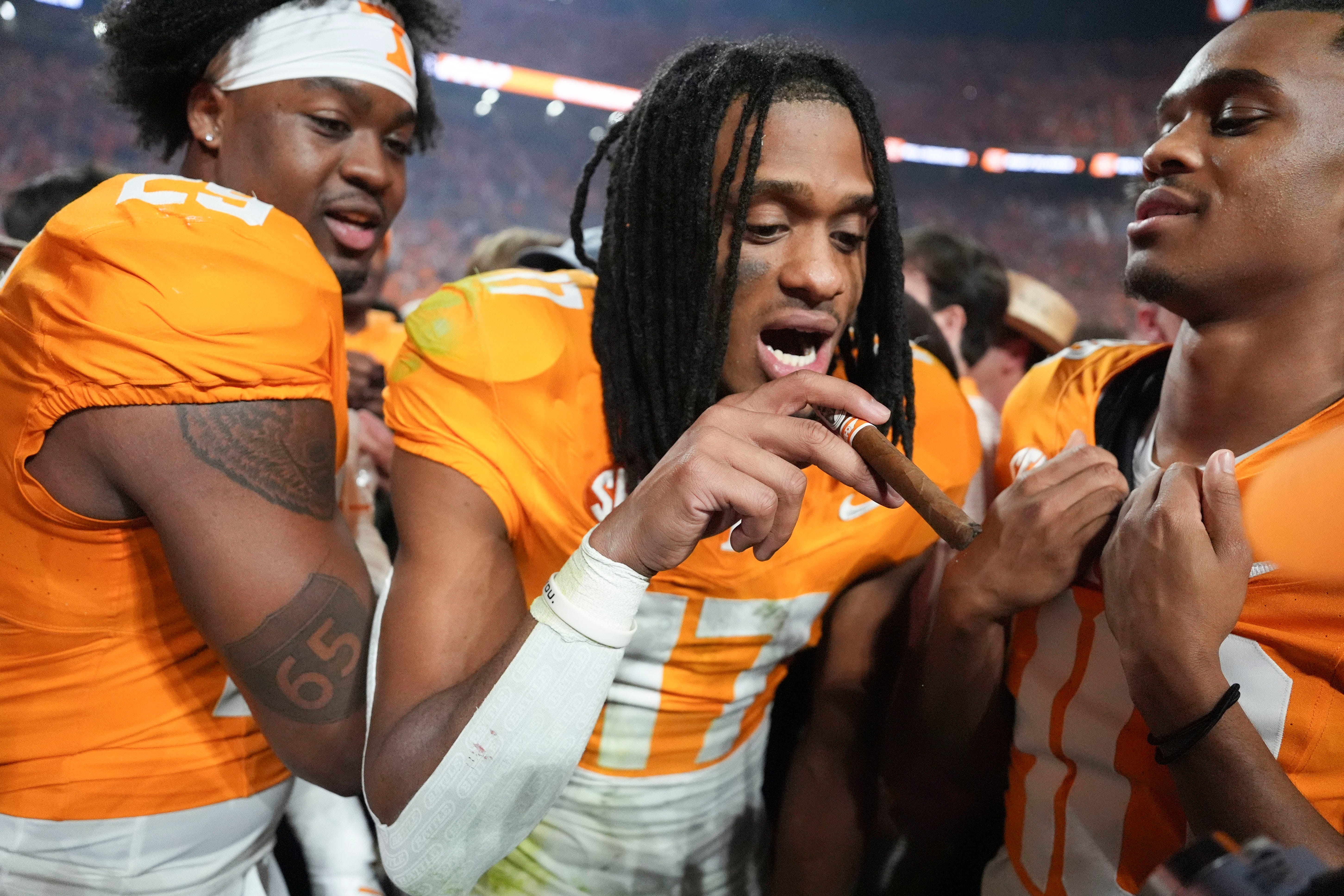 Tennessee wide receiver Chris Brazzell II (17), defensive lineman Jordan Ross (29), and defensive back Colin Brazzell (40) celebrating after the win over Alabama in an NCAA college football game on Saturday, Oct. 19, 2024, in Knoxville. Tenn.