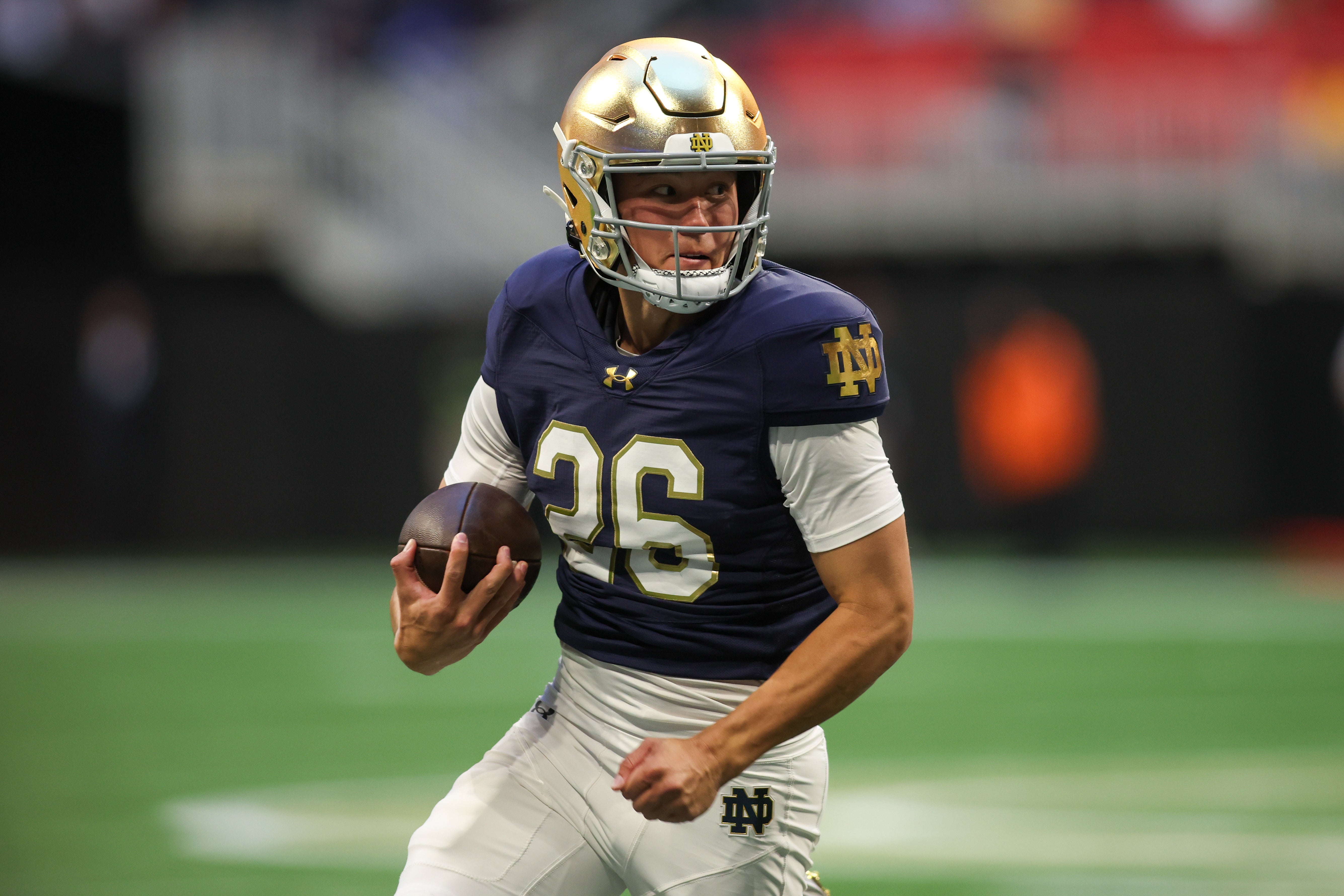 Notre Dame Fighting Irish holder Tyler Buchner (26) runs the ball on a fake field goal against the Georgia Tech Yellow Jackets in the fourth quarter at Mercedes-Benz Stadium.