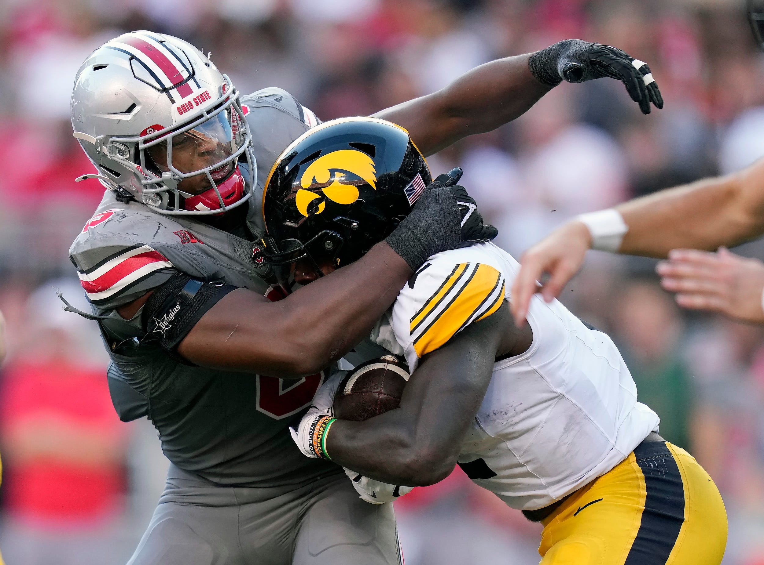 Ohio State Buckeyes safety Sonny Styles (6) tackles Iowa Hawkeyes running back Kaleb Johnson (2) in the back field in the third quarter during the NCAA football game at Ohio Stadium.