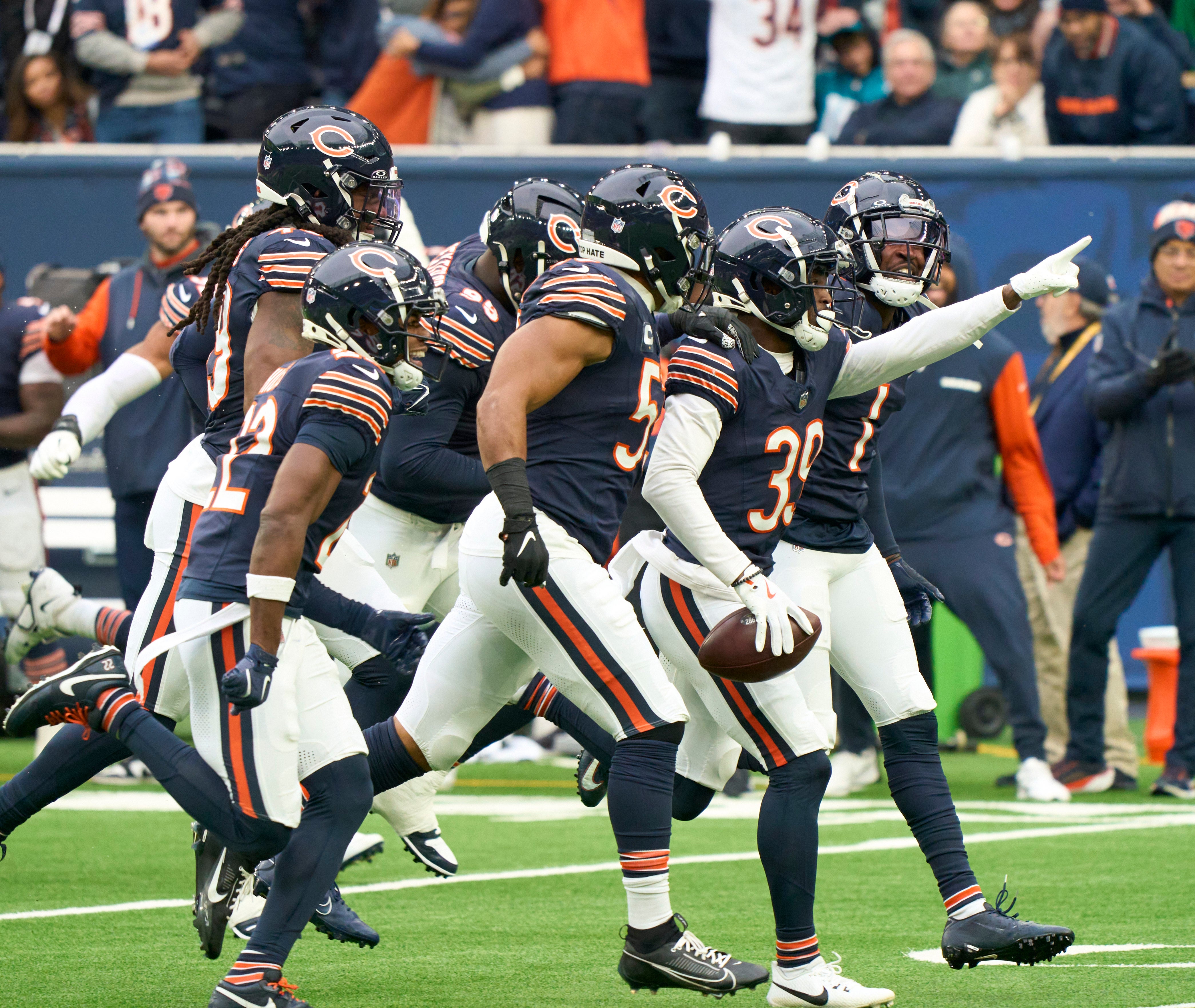 Oct 13, 2024; London, United Kingdom; Chicago Bears teammates celebrate a turnover during the second half of an NFL International Series game at Tottenham Hotspur Stadium.