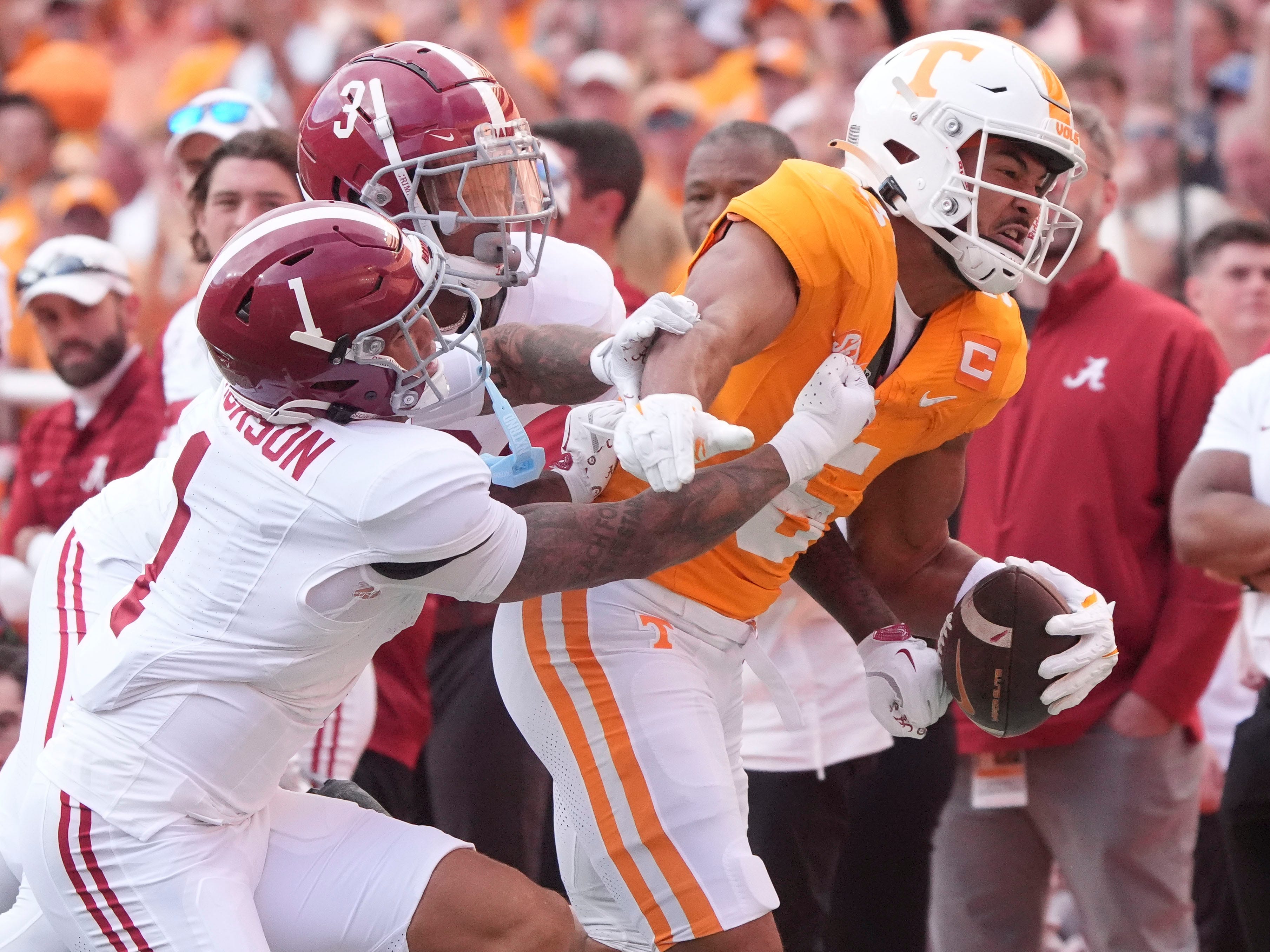 Tennessee wide receiver Bru McCoy (5) tries to fight off Alabama defensive backs Domani Jackson (1) and Keon Sabb (3) during an NCAA college football game on Saturday, Oct. 19, 2024, in Knoxville. Tenn.