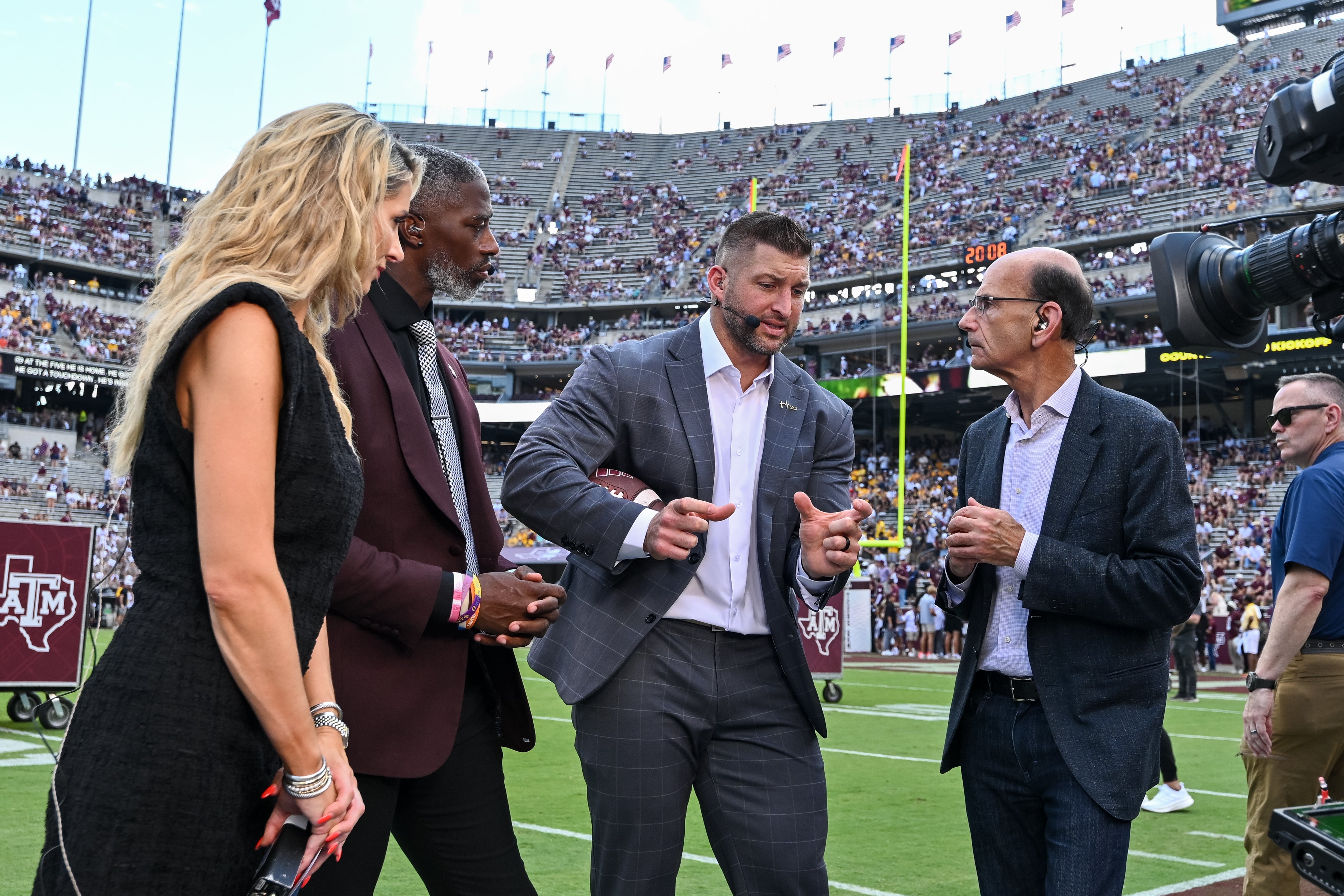 Oct 5, 2024; College Station, Texas, USA; SEC Nation host Laura Rutledge, analyst Roman Harper, analyst Tim Tebow and analyst Paul Finebaum speak prior to the game between the Texas A&M Aggies and the Missouri Tigers at Kyle Field.