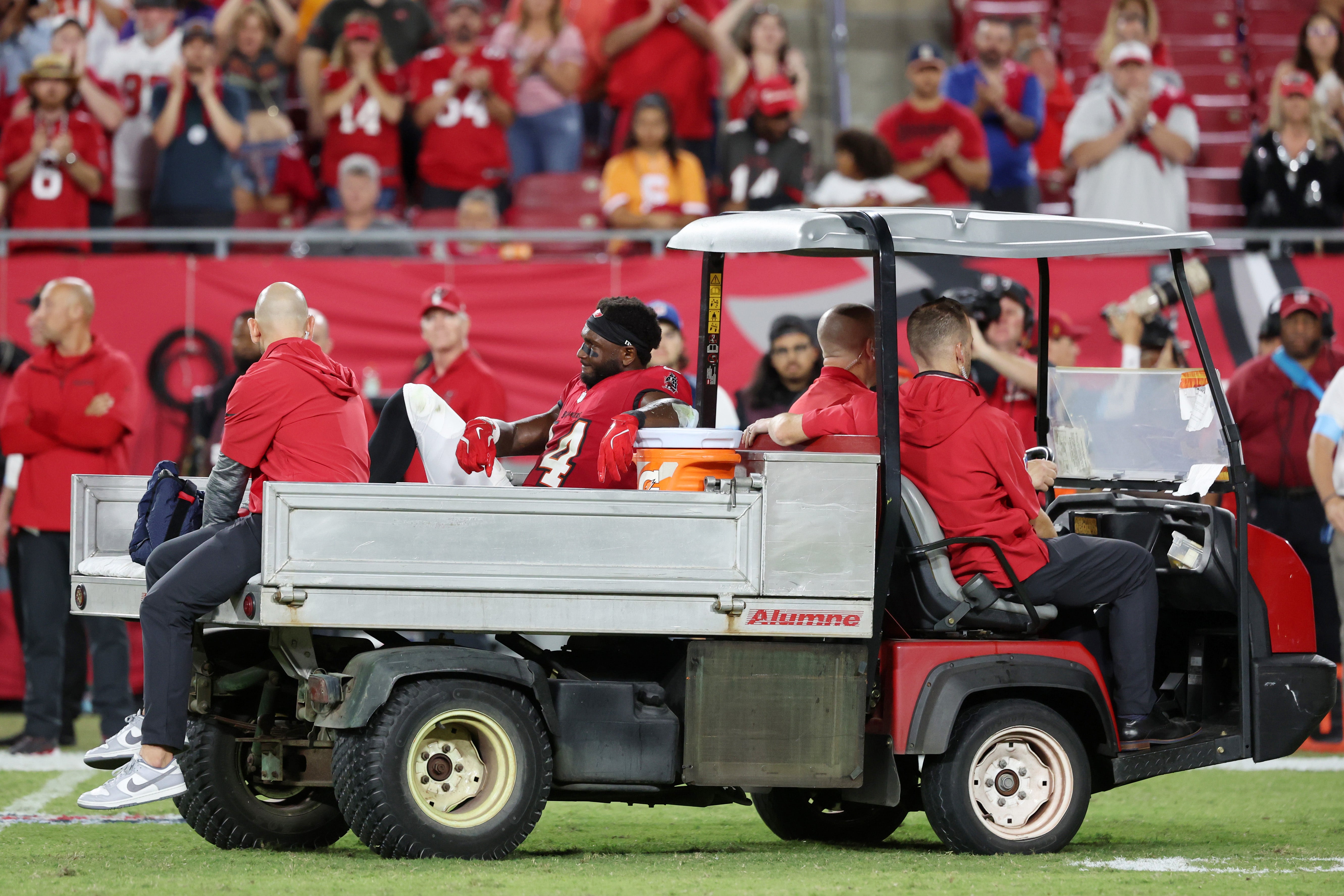 Oct 21, 2024; Tampa, Florida, USA; Tampa Bay Buccaneers wide receiver Chris Godwin (14) is carted off the field after an apparent injury against the Baltimore Ravens during the second half at Raymond James Stadium.