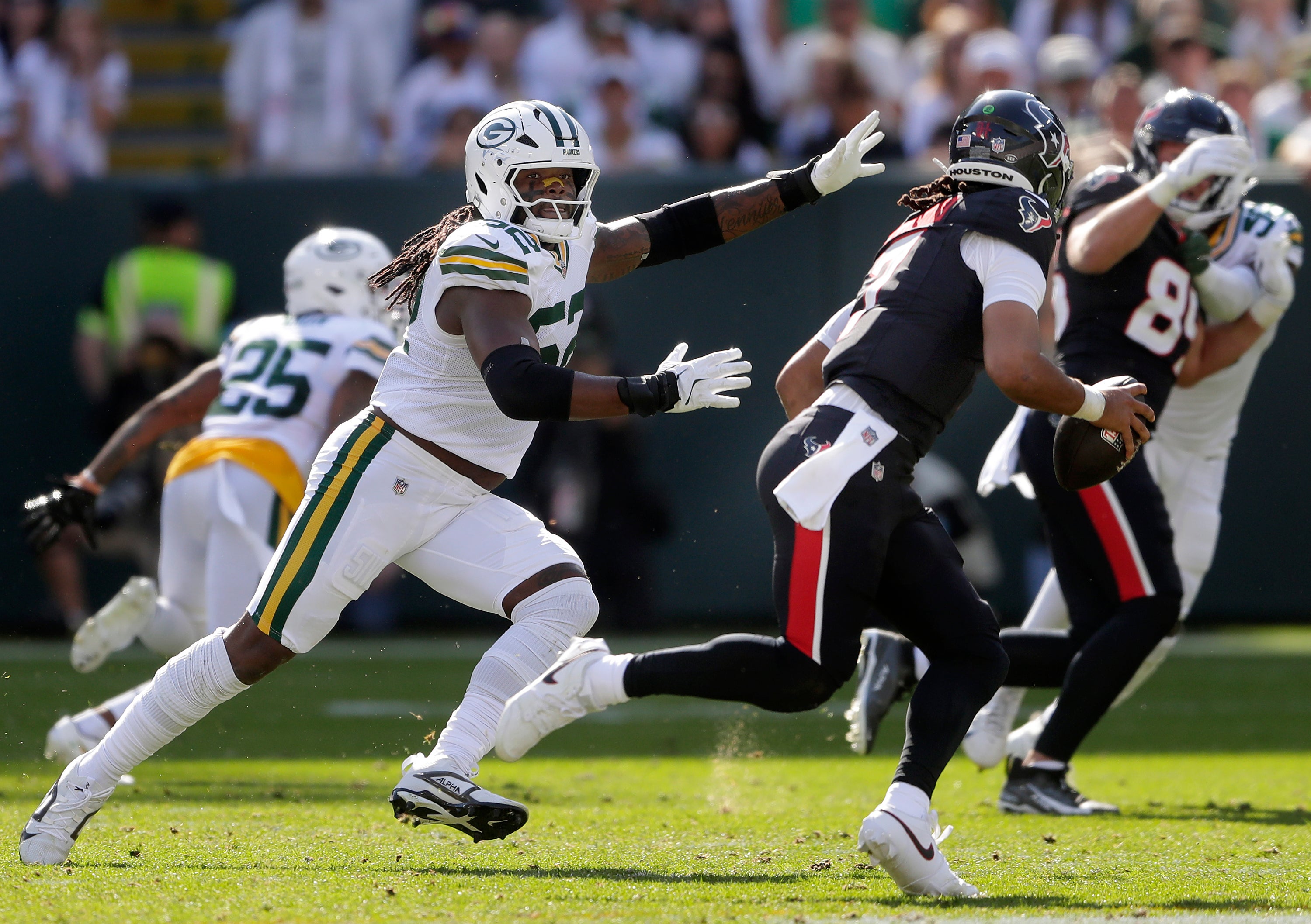 Green Bay Packers defensive end Rashan Gary (52) chases Houston Texans quarterback C.J. Stroud (7) at Lambeau Field