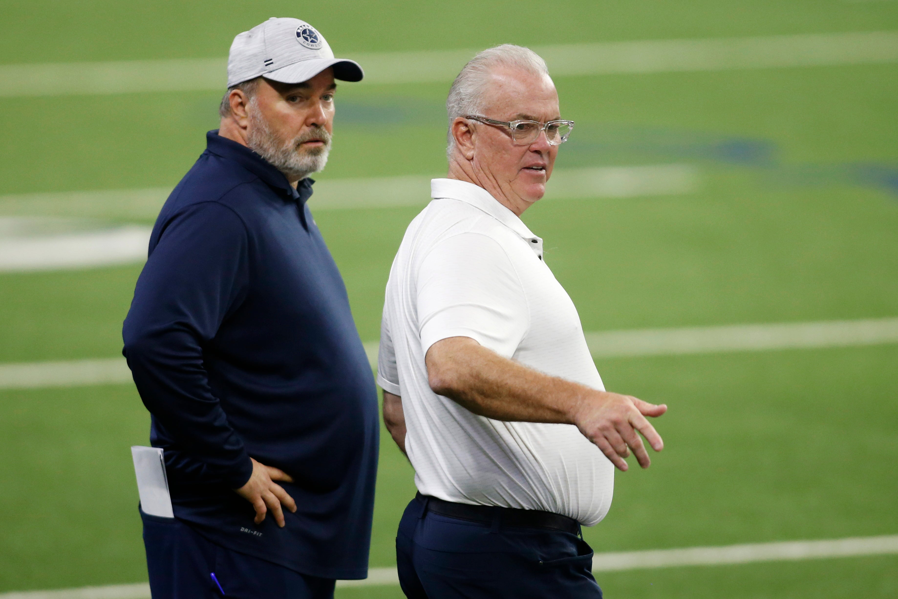 Dallas Cowboys head coach Mike McCarthy (L) and CEO Stephen Jones (R) on the field during minicamp at the Ford Center at the Star Training Facility in Frisco, Texas.