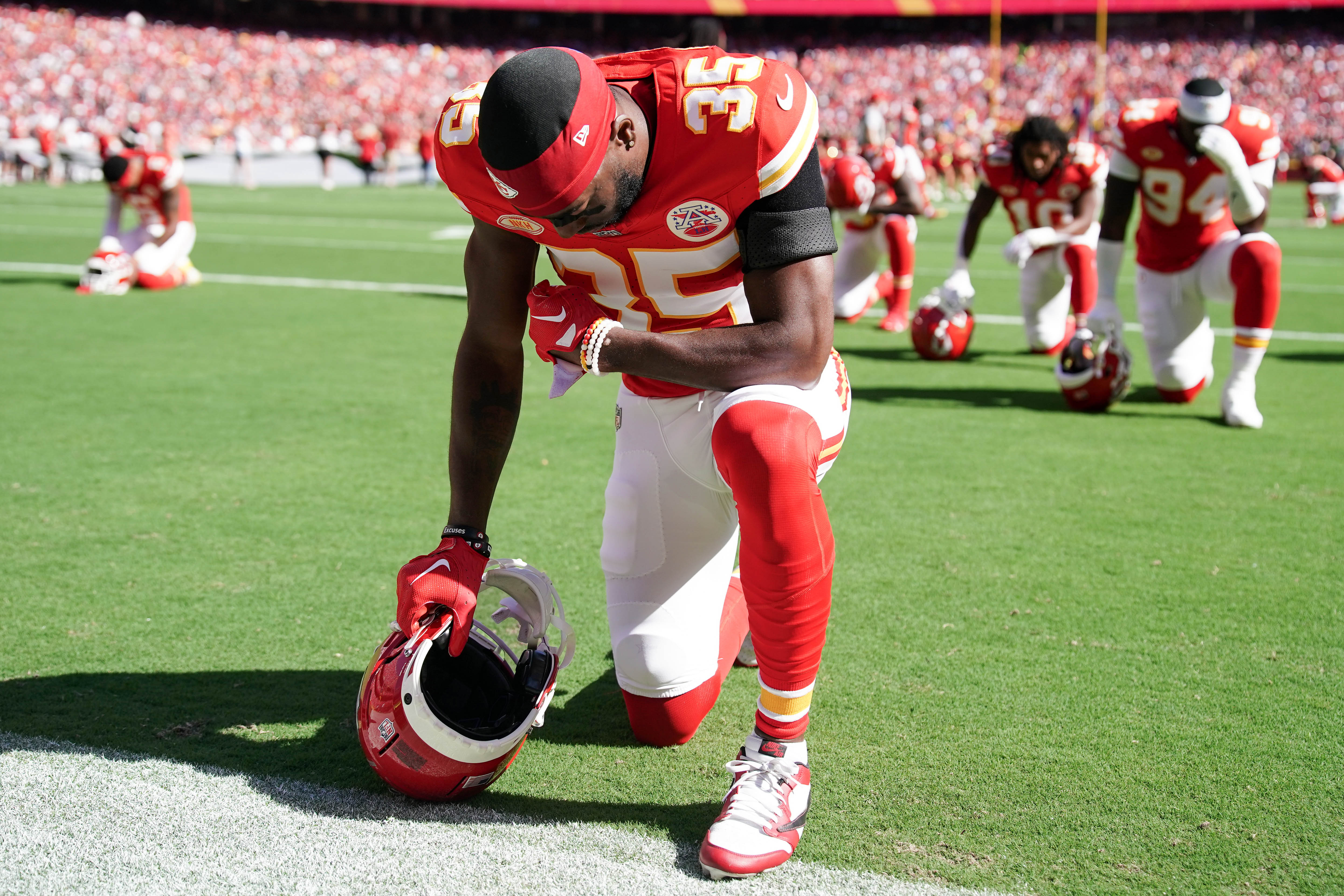 Sep 24, 2023; Kansas City, Missouri, USA; Kansas City Chiefs cornerback Jaylen Watson (35) kneels on field against the Chicago Bears prior to a game at GEHA Field at Arrowhead Stadium.