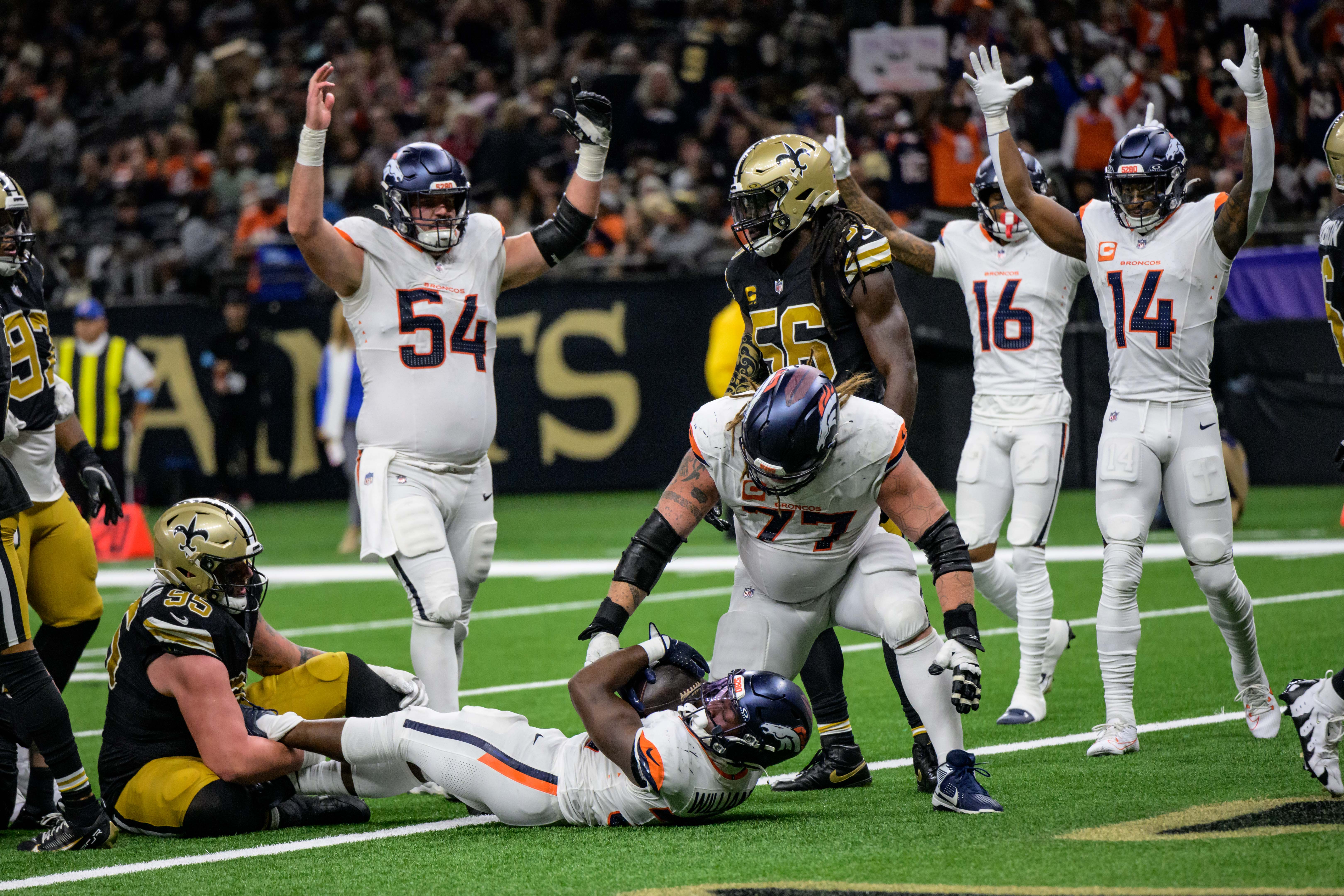 Broncos running back Audric Estime scores a touchdown against Saints.