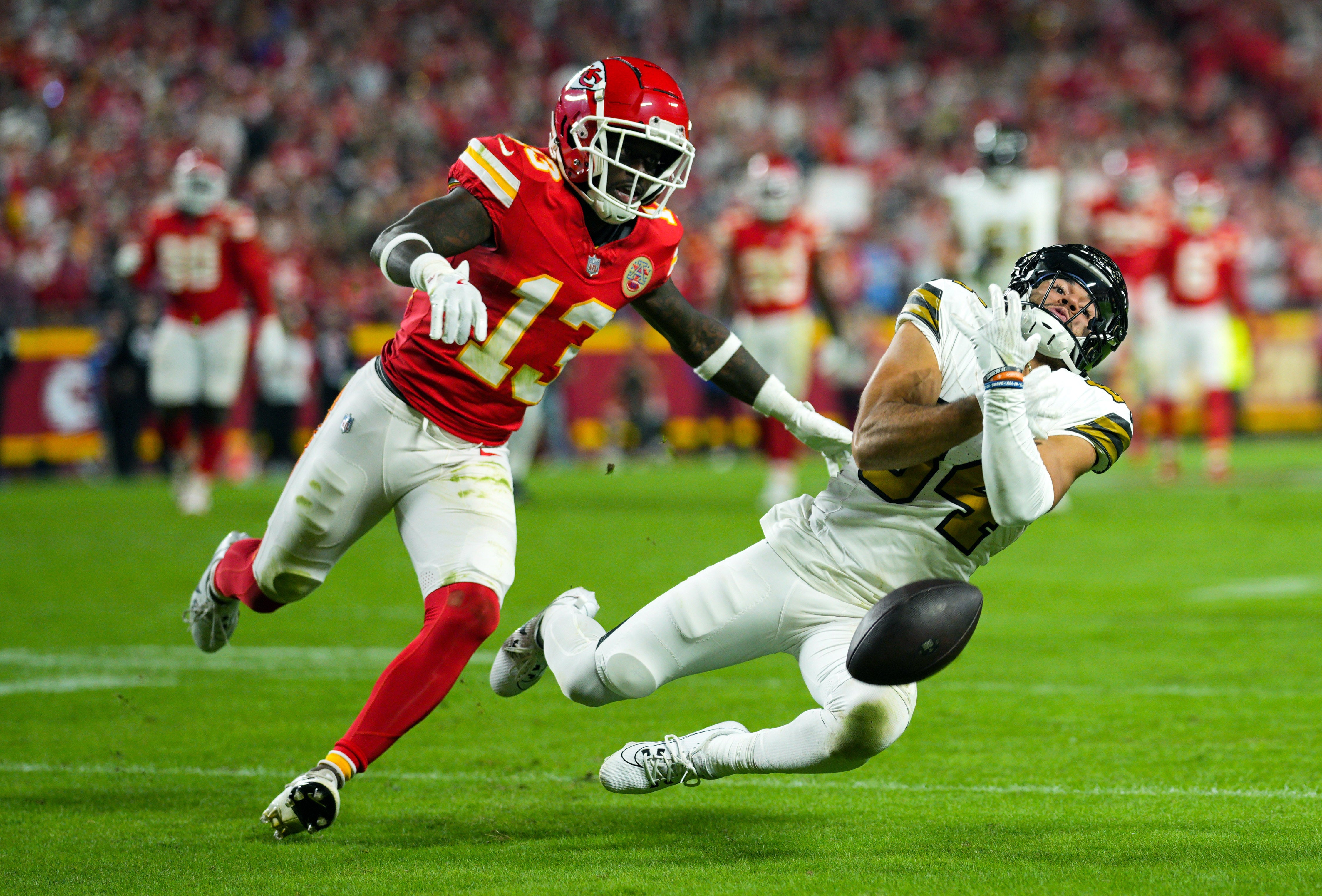 Oct 7, 2024; Kansas City, Missouri, USA; New Orleans Saints wide receiver Mason Tipton (84) is unable to make the a catch against Kansas City Chiefs safety Nazeeh Johnson (13) during the second half at GEHA Field at Arrowhead Stadium.