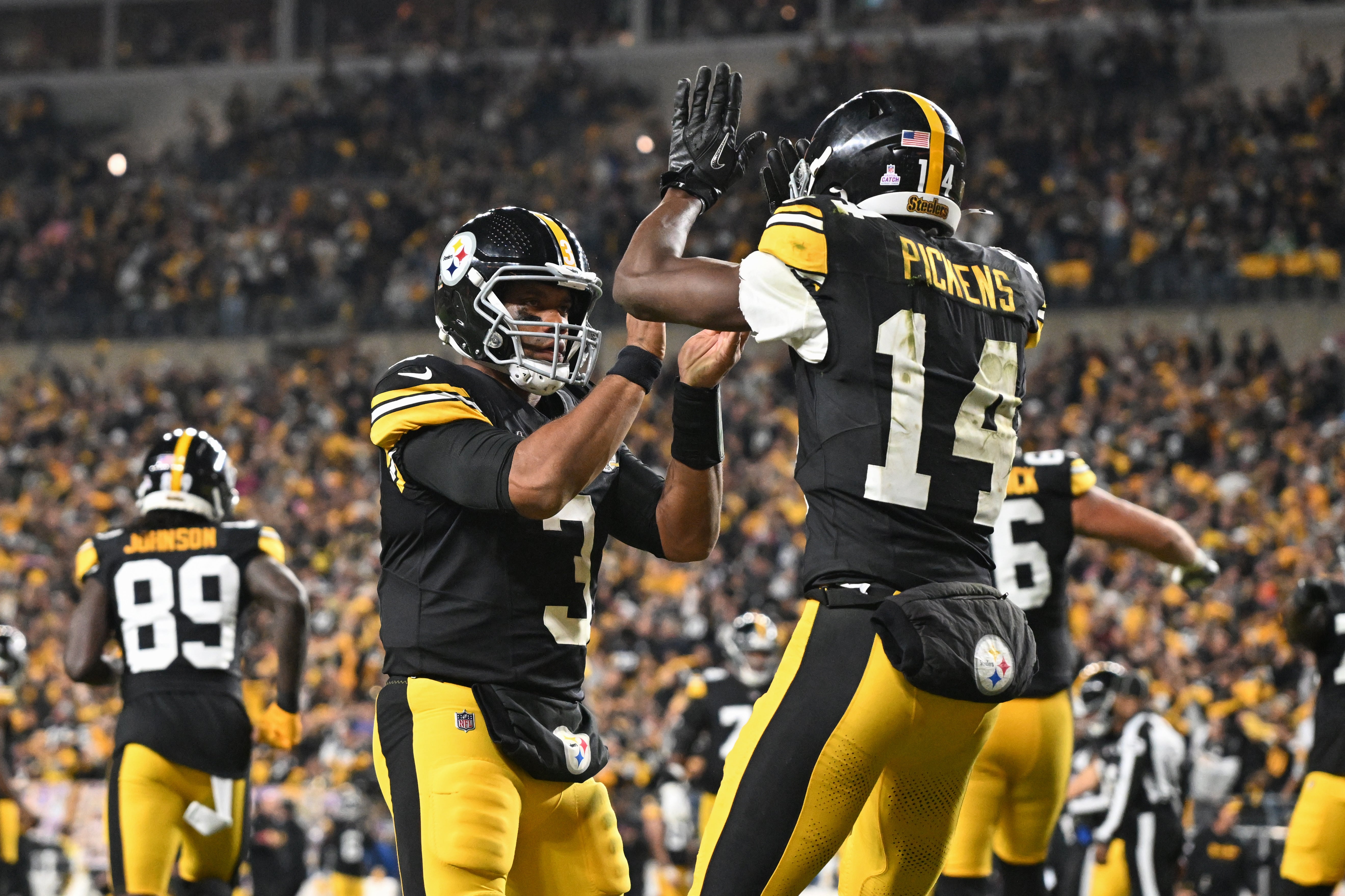 Steelers wide receiver George Pickens celebrates an 11 yard touchdown pass with quarterback Russell Wilson.