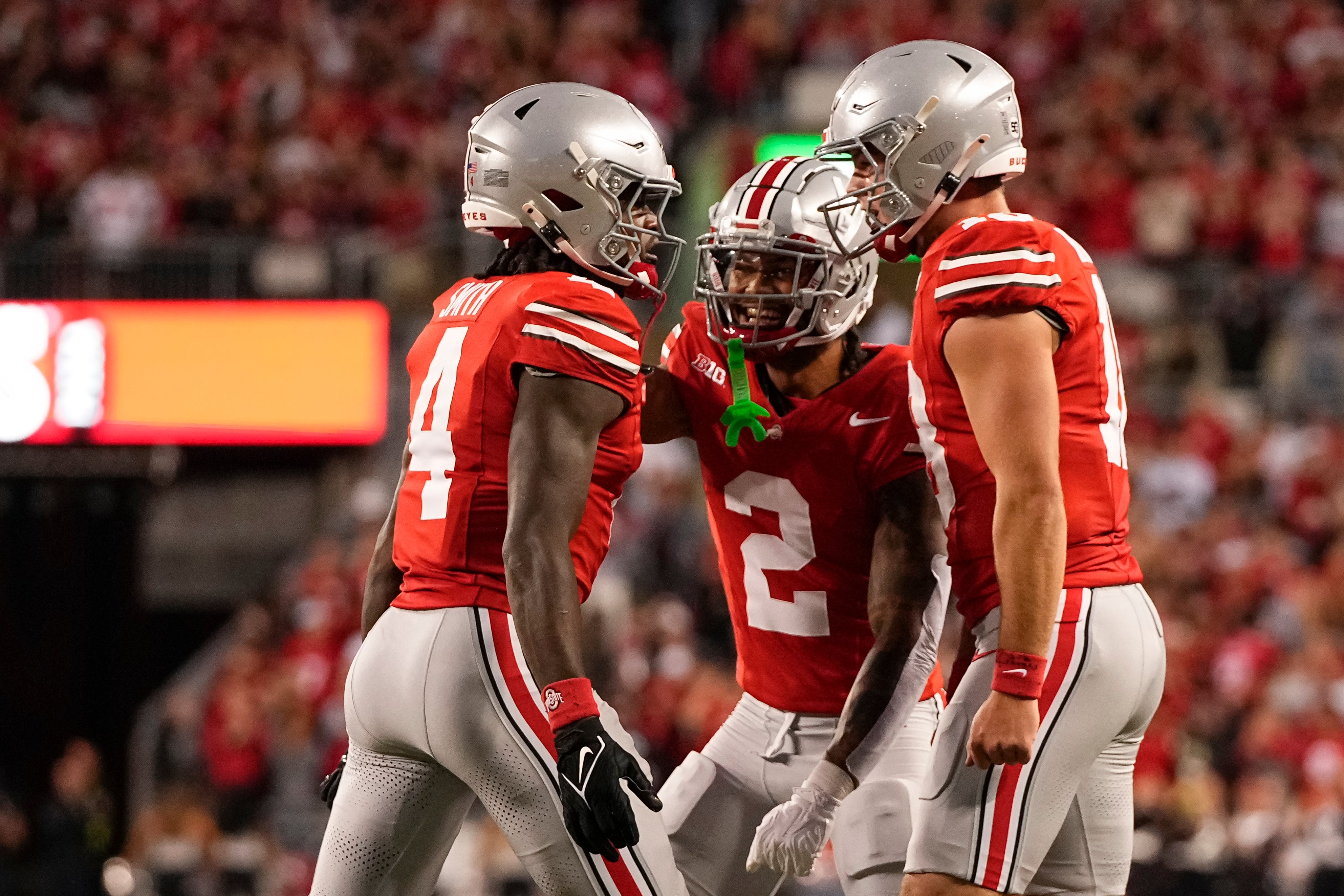 Ohio State Buckeyes wide receiver Jeremiah Smith (4) celebrates with wide receiver Emeka Egbuka (2) and quarterback Will Howard (18) after scoring a touchdown against the Western Michigan Broncos during the first half at Ohio Stadium.