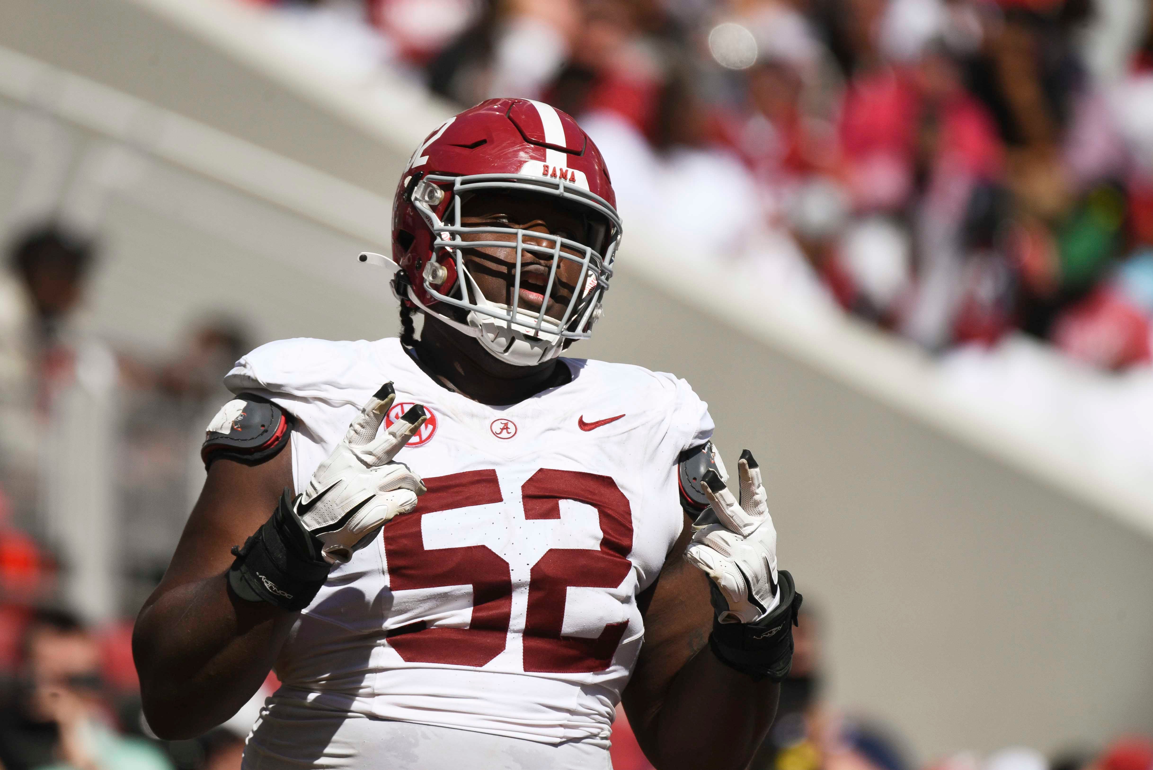 Alabama offensive lineman Tyler Booker (52) celebrates after the offense scored a touchdown during the A-Day scrimmage at Bryant-Denny Stadium.