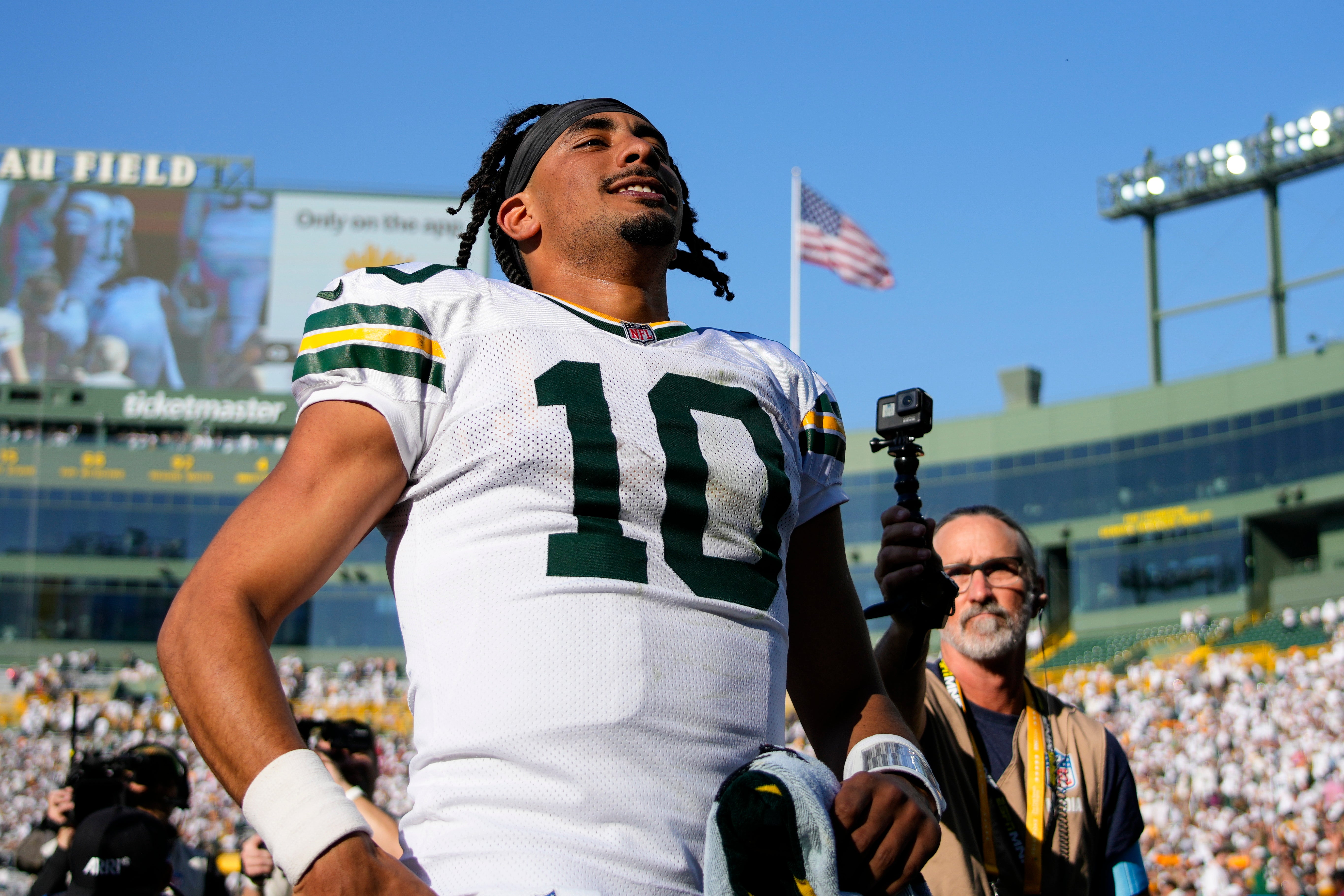 Green Bay Packers quarterback Jordan Love (10) celebrates as he runs off the field following the game against the Houston Texans at Lambeau Field.