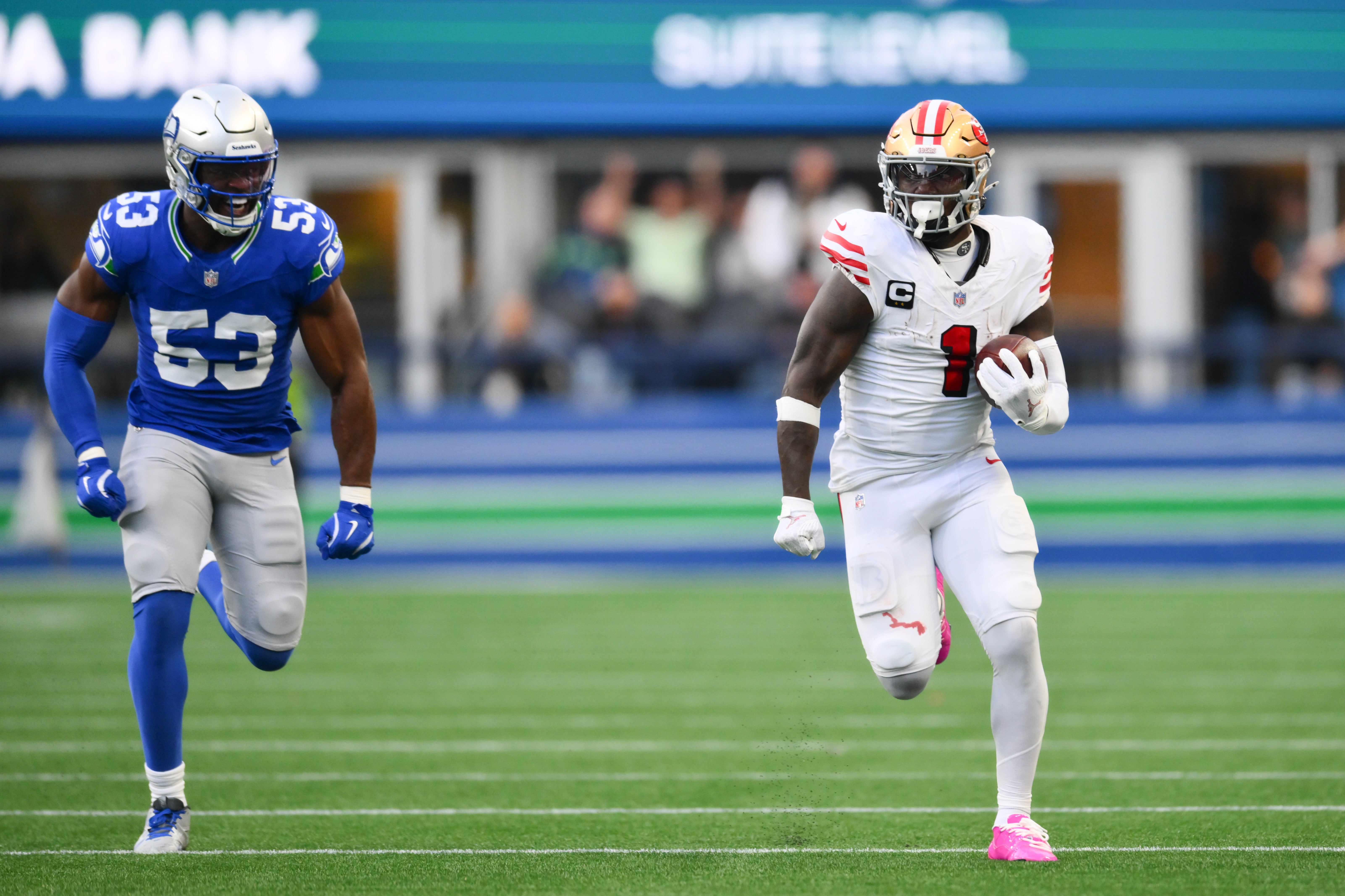San Francisco 49ers wide receiver Deebo Samuel Sr. (1) runs away from Seattle Seahawks linebacker Boye Mafe (53) to score a 76-yard touchdown during the first half at Lumen Field.