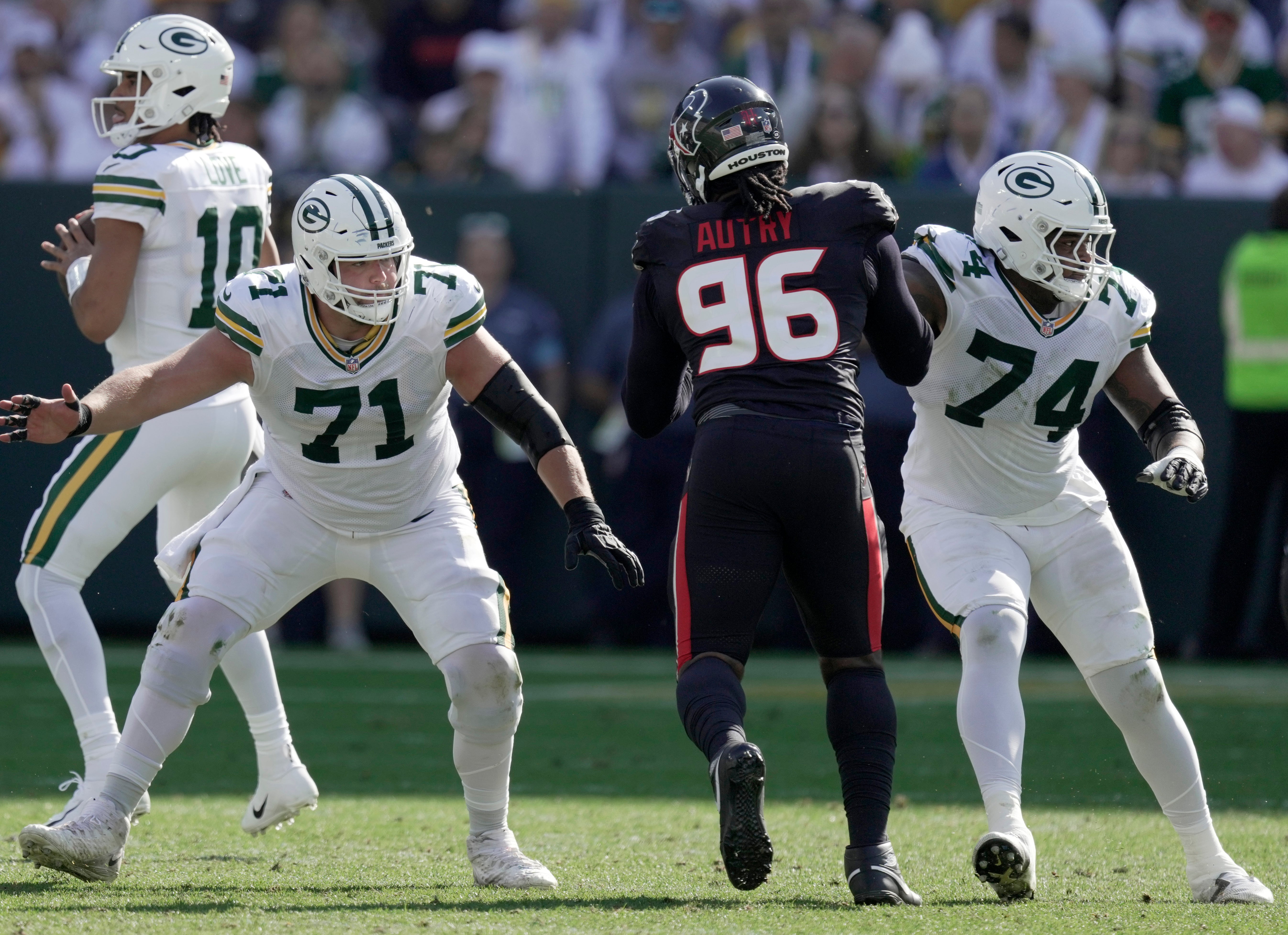 Green Bay Packers center Josh Myers (71) and guard Elgton Jenkins (74) provide pass protection for quarterback Jordan Love (10) during the second quarter of their game at Lambeau Field.