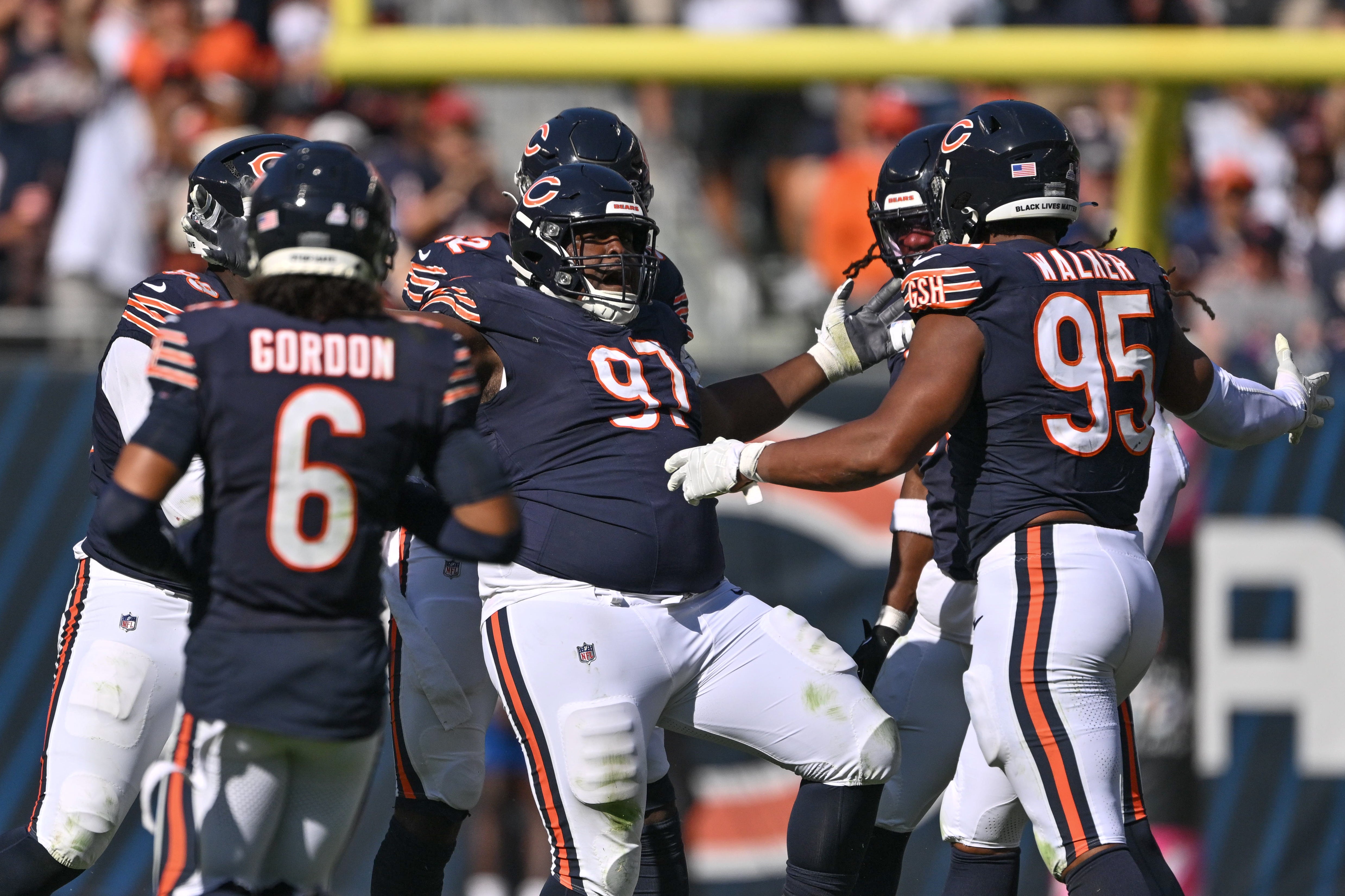 Oct 6, 2024; Chicago, Illinois, USA; Chicago Bears defensive tackle Andrew Billings (97) celebrates his sack with teammates against the Carolina Panthers during the fourth quarter at Soldier Field.