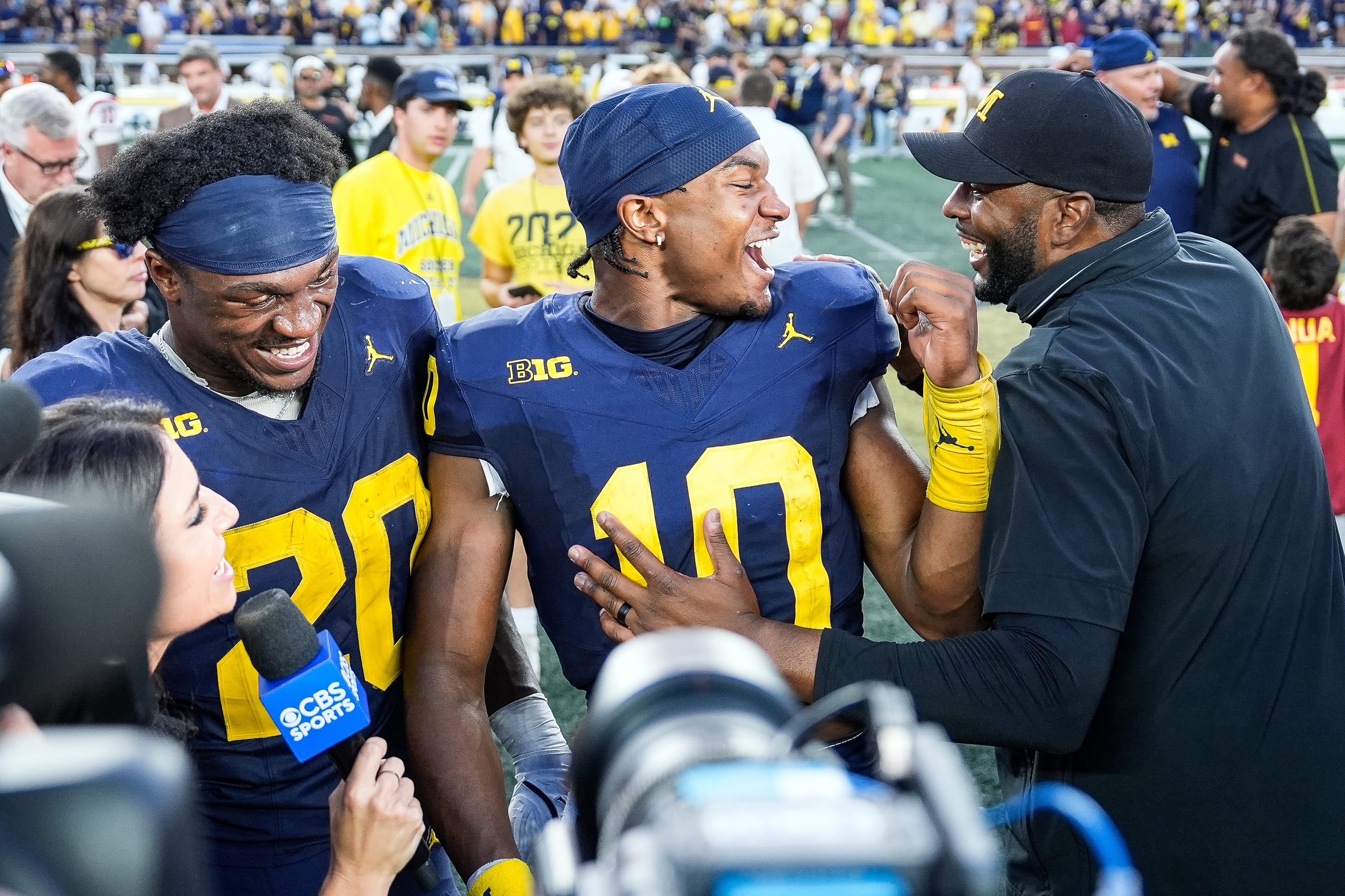 Michigan head coach Sherrone Moore, right, talks to quarterback Alex Orji (10) and running back Kalel Mullings (20) after 27-24 win over USC at Michigan Stadium in Ann Arbor on Saturday, Sept. 21, 2024.