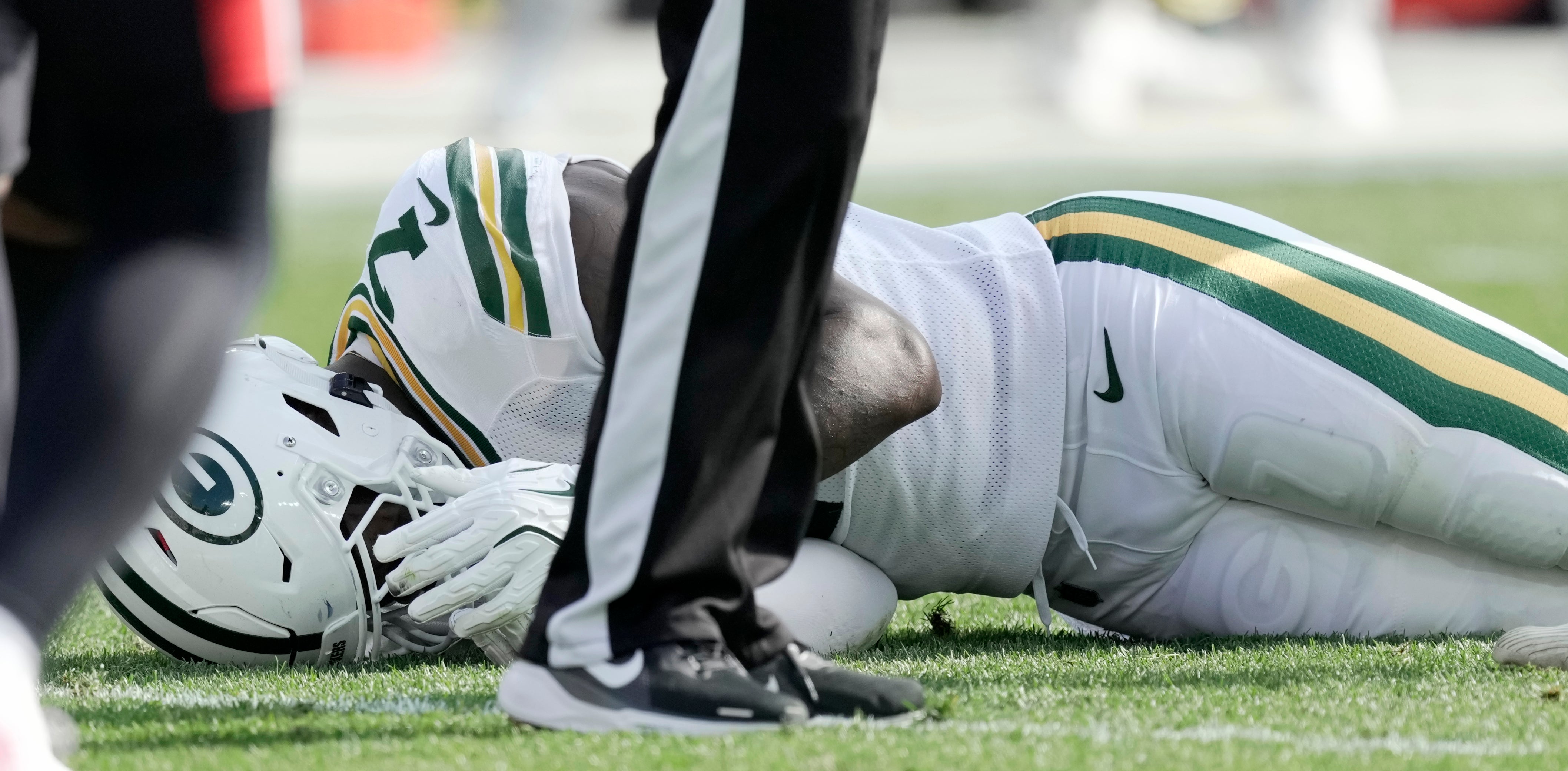 Green Bay Packers linebacker Quay Walker (7) is tended to after being injured during the second quarter of their game at Lambeau Field.