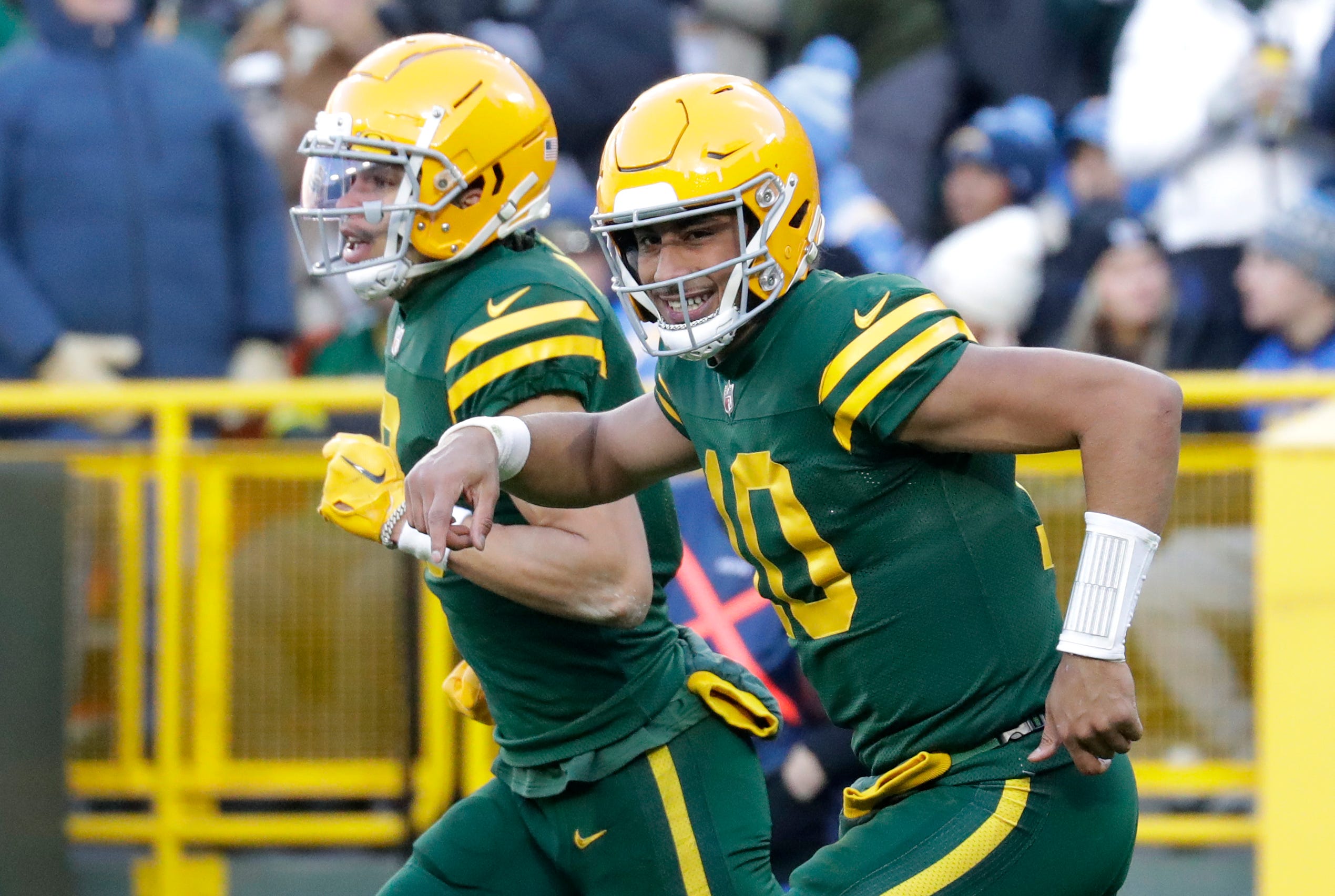 Green Bay Packers quarterback Jordan Love (10) smiles as he runs off the field with wide receiver Christian Watson (9) after the two connected on a touchdown pass against the Los Angeles Chargers in the thrid quarter during their football game Sunday, November 19, 2023, at Lambeau Field in Green Bay, Wis.