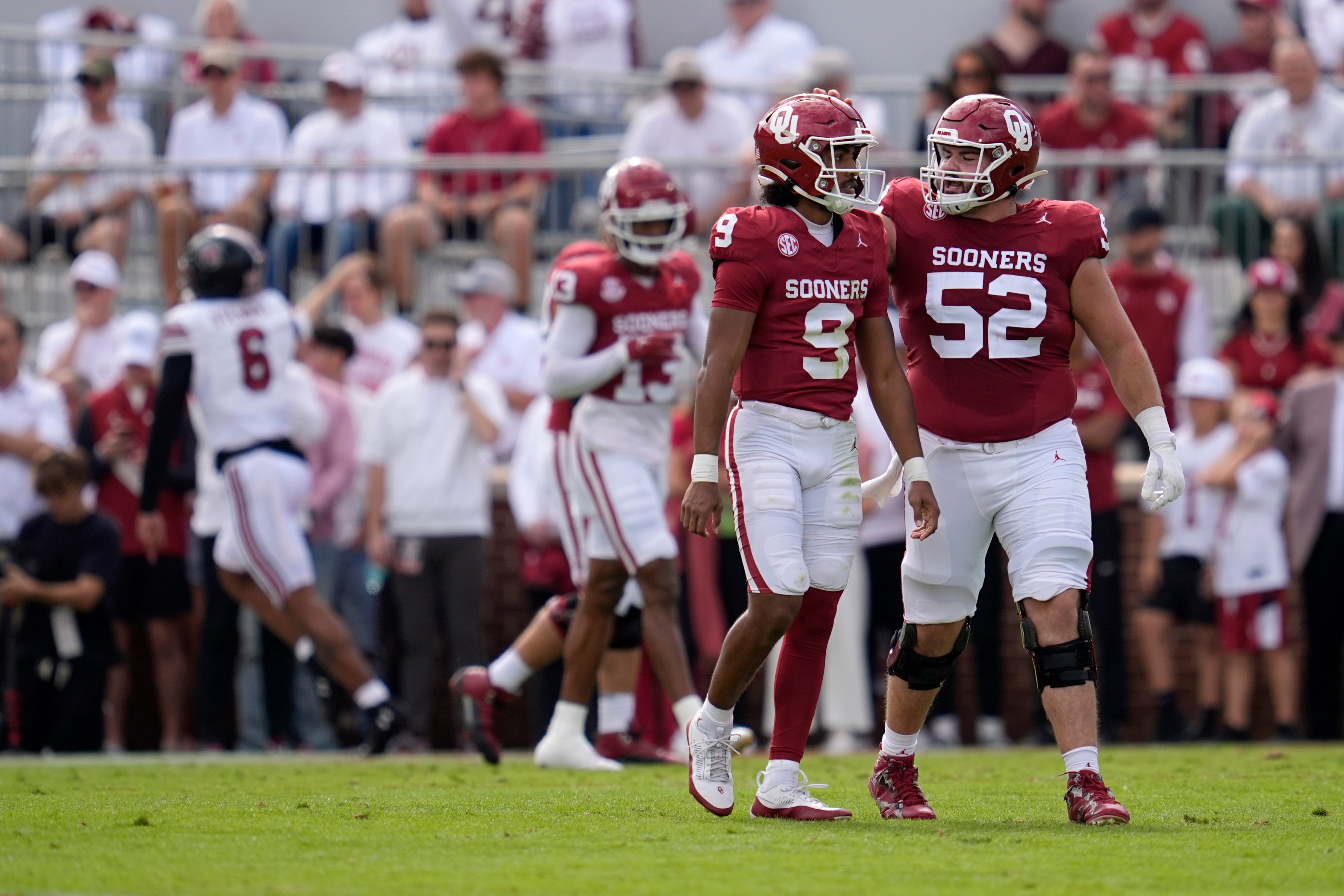 Oklahoma Sooners running back Taylor Tatum (8) walks off the field beside Oklahoma Sooners offensive lineman Troy Everett (52) after a fumble that was returned for a touchdown during a college football game between the University of Oklahoma Sooners (OU) and the South Carolina Gamecocks at Gaylord Family - Oklahoma Memorial Stadium in Norman, Okla., Saturday, Oct. 19, 2024.