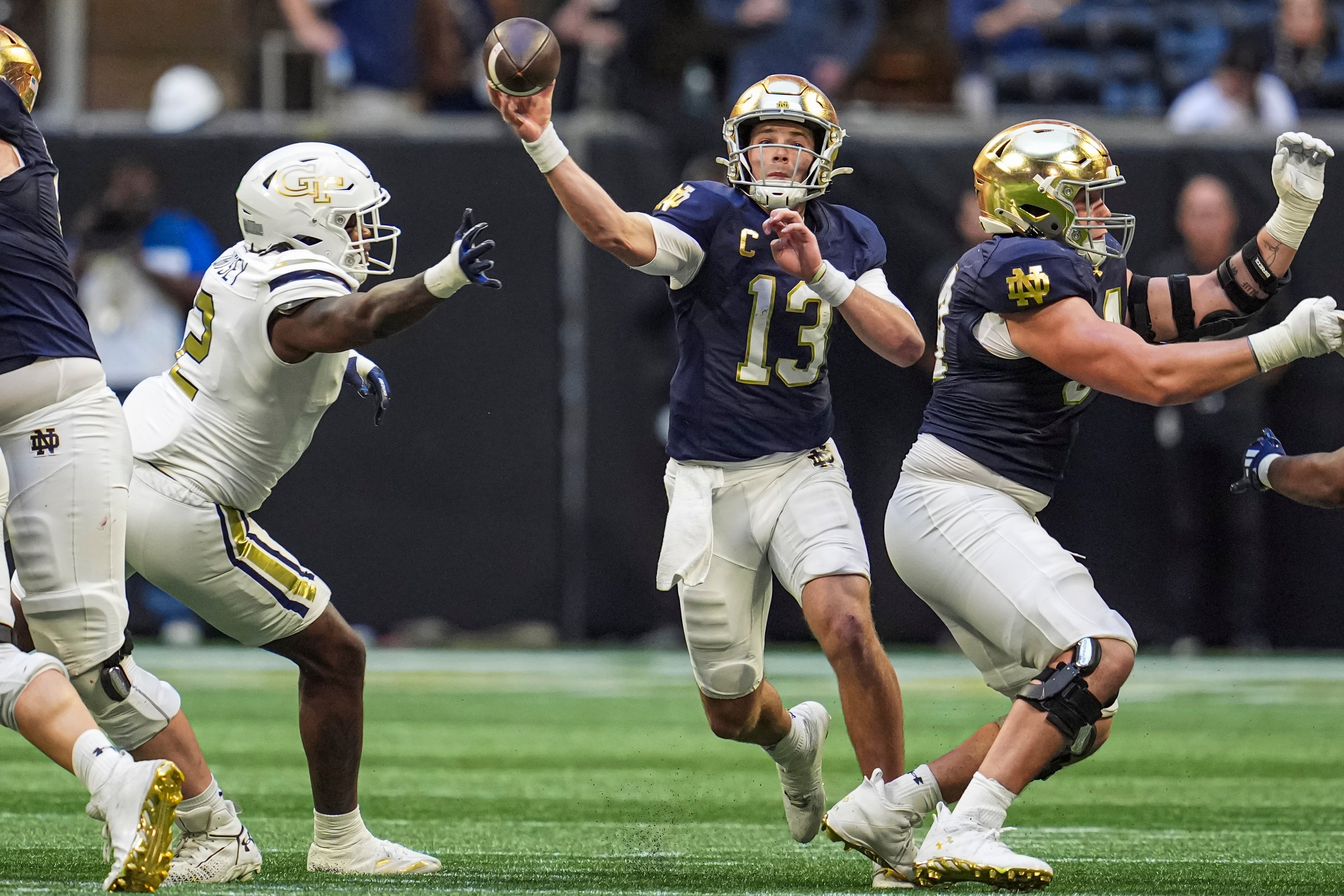 Notre Dame Fighting Irish quarterback Riley Leonard (13) passes against the Georgia Tech Yellow Jackets at Mercedes-Benz Stadium.