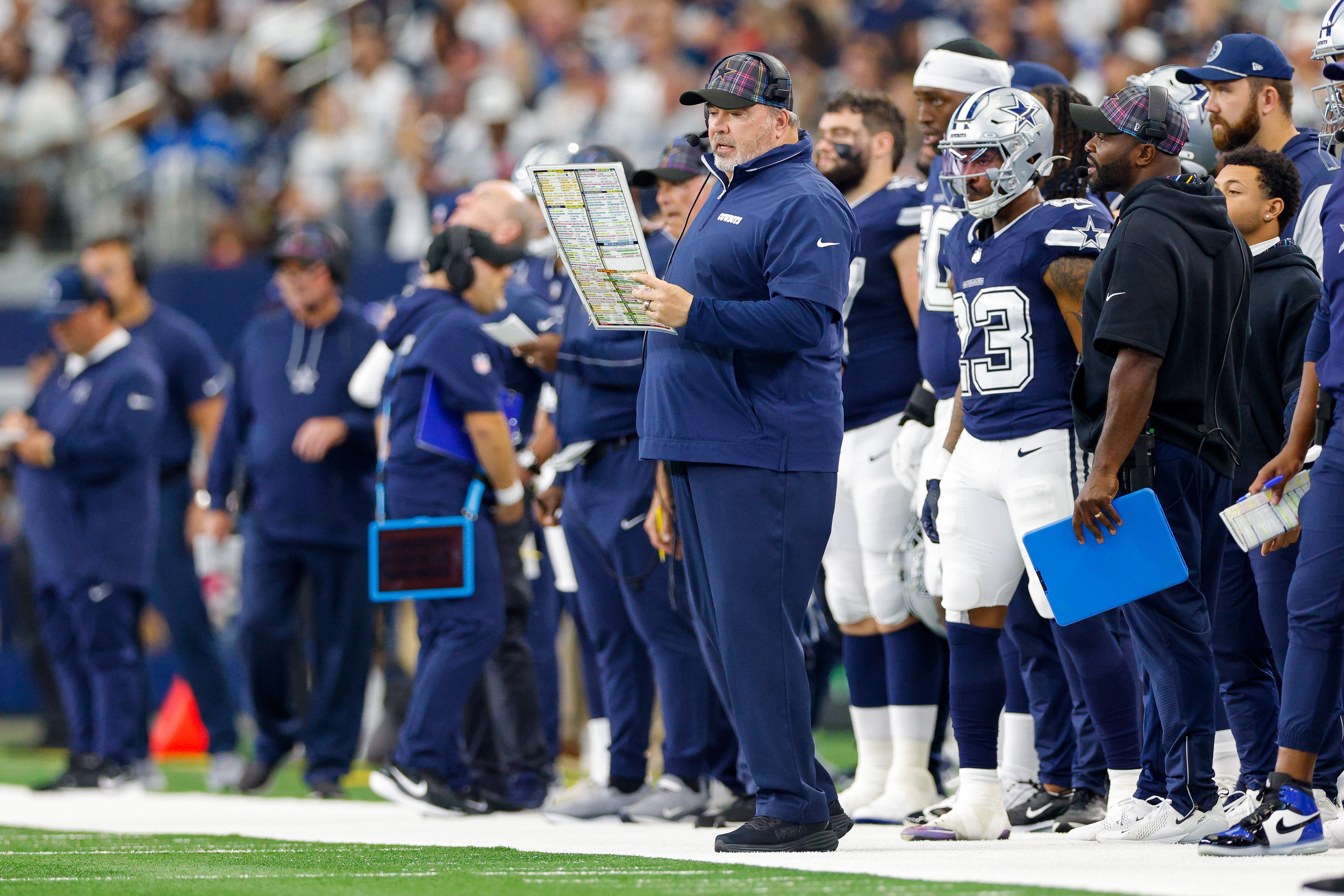Dallas Cowboys Head Coach Mike McCarthy looks over the play chart during the first quarter against the Detroit Lions at AT&T Stadium.
