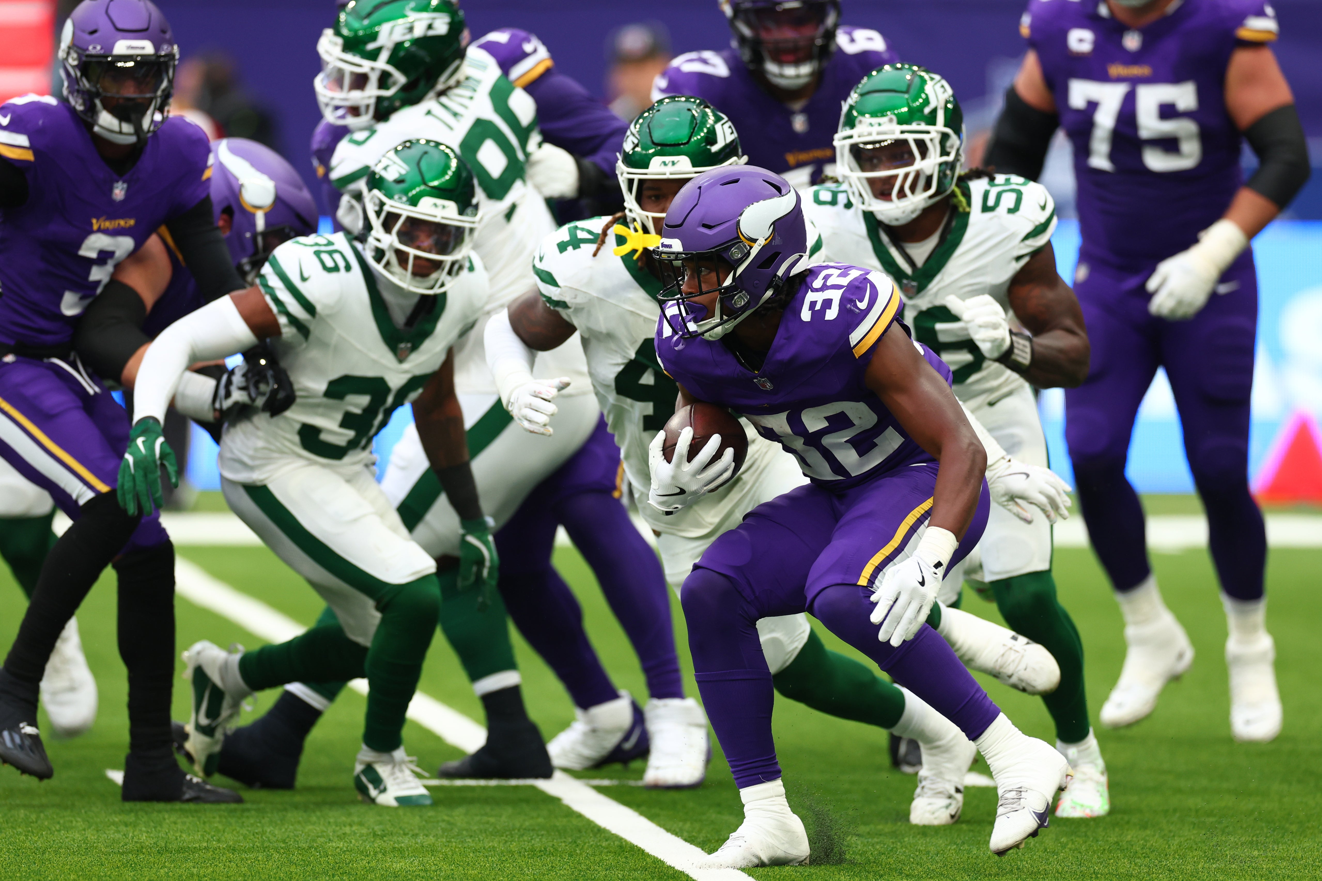 Oct 6, 2024; Tottenham, ENG; Minnesota Vikings Running Back Ty Chandler (32) runs a first down in the 2nd Quarter against New York Jets at Tottenham Hotspur Stadium.