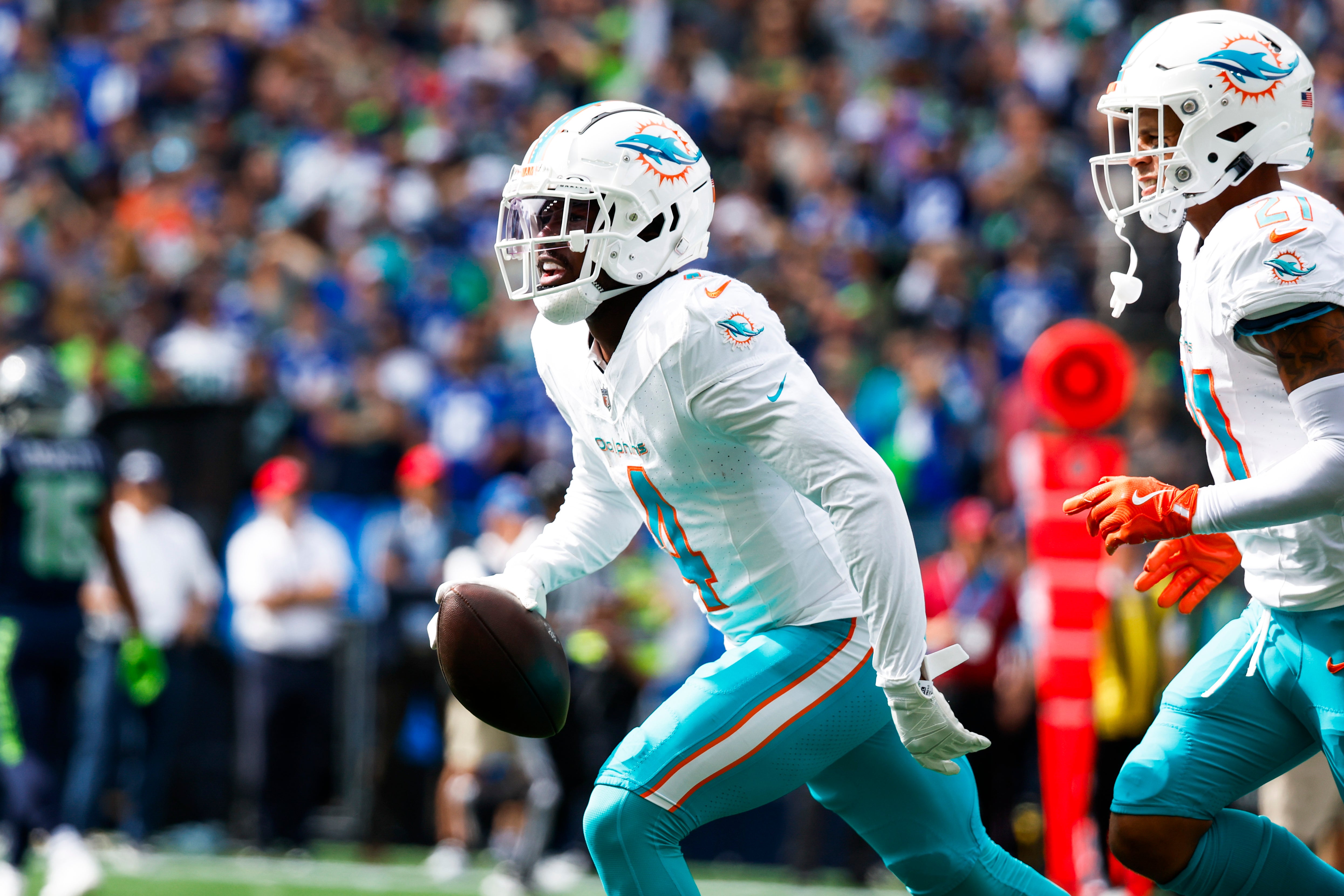 Miami Dolphins cornerback Kader Kohou (4) celebrates following an interception against the Seattle Seahawks during the first quarter at Lumen Field.