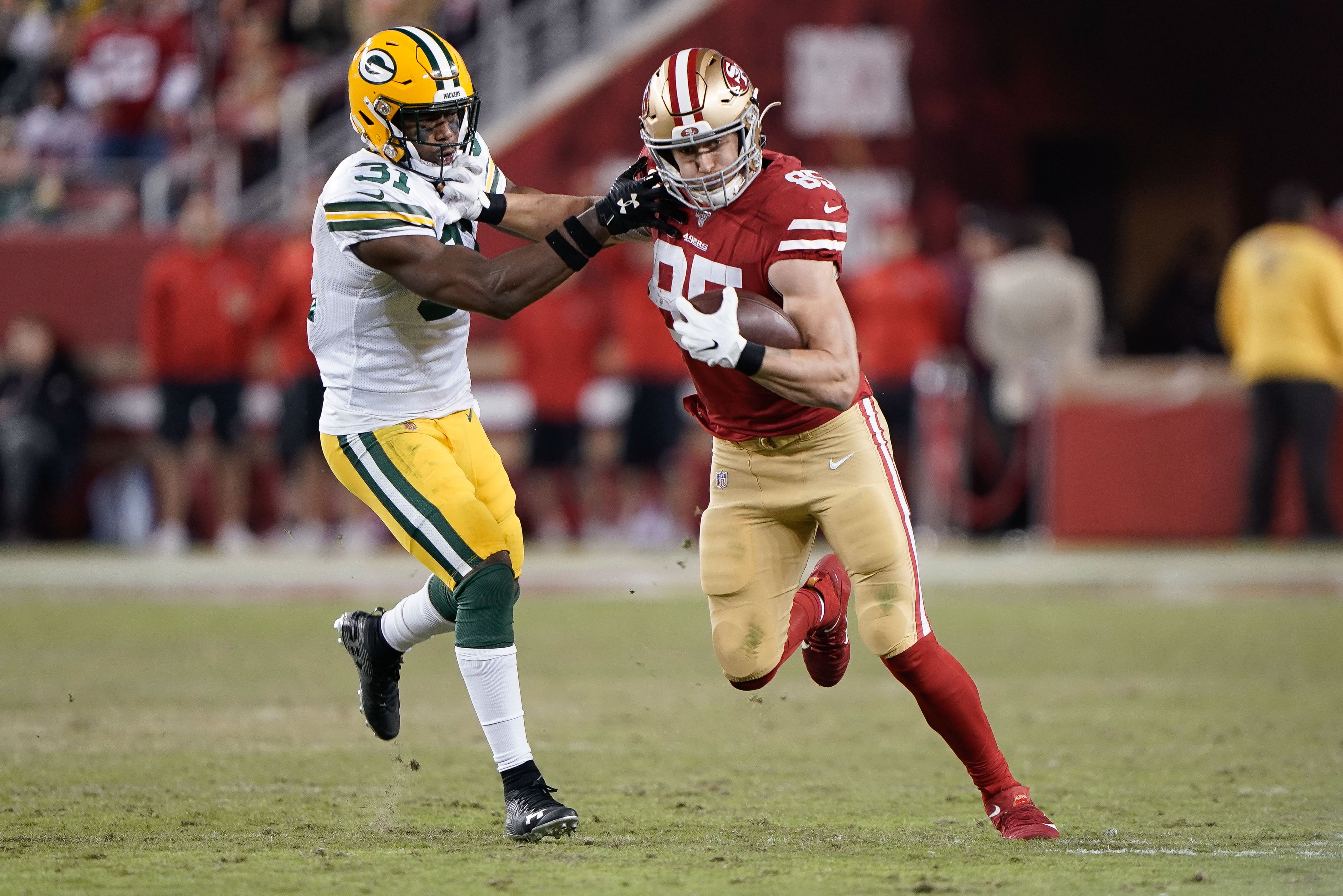 San Francisco 49ers tight end George Kittle (85) runs past Green Bay Packers strong safety Adrian Amos (31) during the second quarter at Levi's Stadium.
