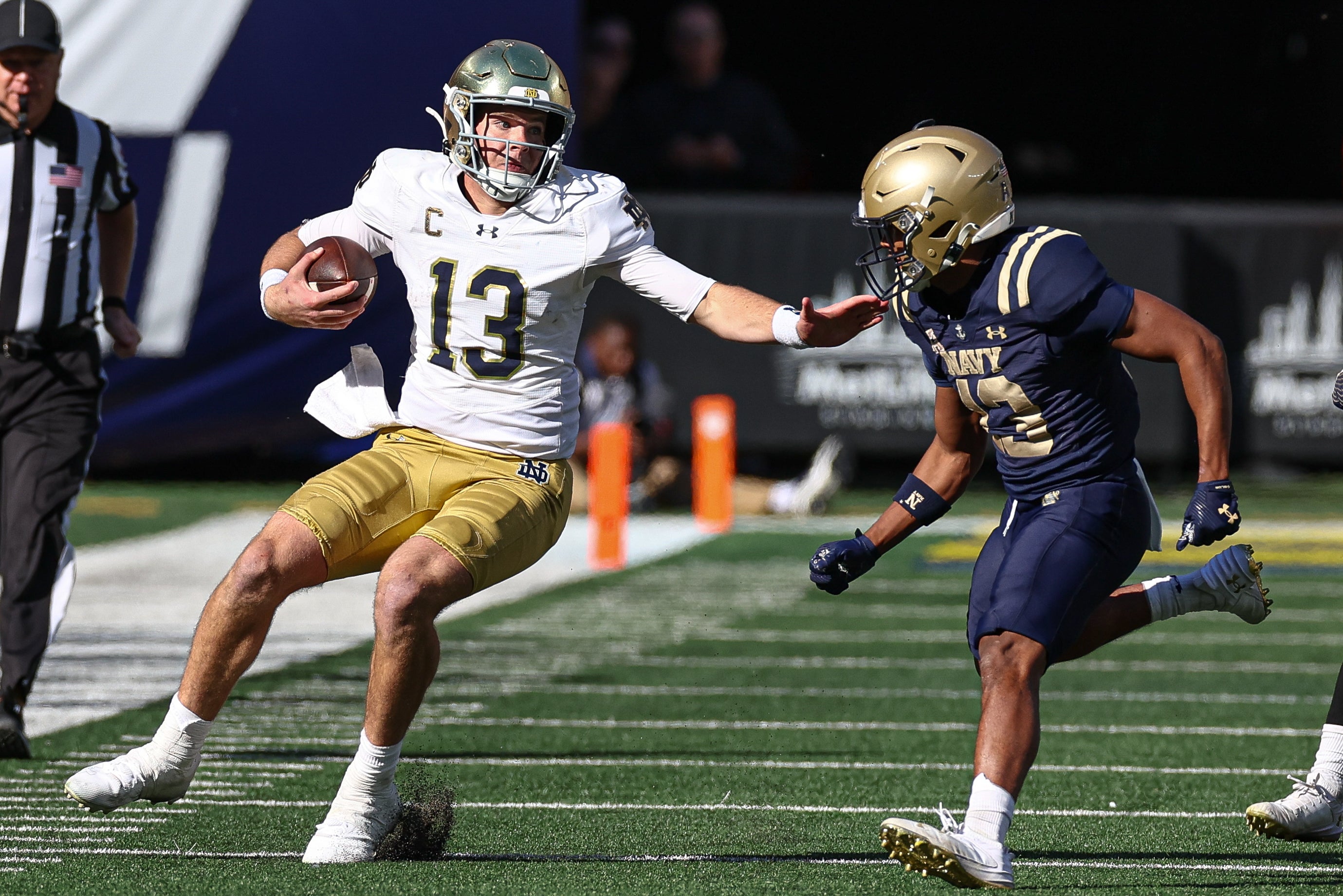 Notre Dame Fighting Irish quarterback Riley Leonard (13) fights off would-be tackler Navy Midshipmen cornerback Andrew Duhart (13) during the second half at MetLife Stadium.