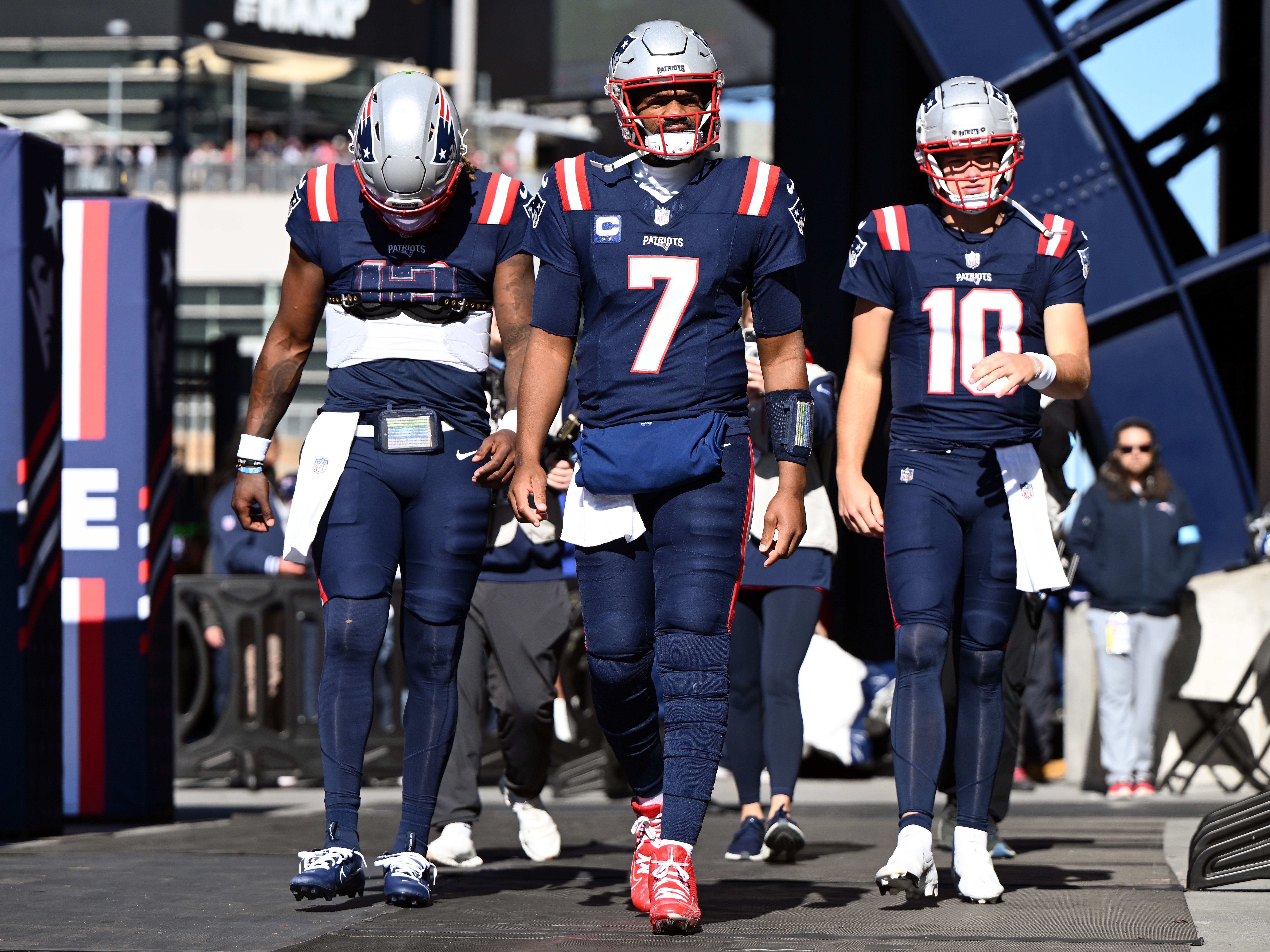 Oct 27, 2024; Foxborough, Massachusetts, USA; New England Patriots quarterback Joe Milton III (19), quarterback Jacoby Brissett (7), and quarterback Drake Maye (10) walk onto the field before a game against the New York Jets at Gillette Stadium.
