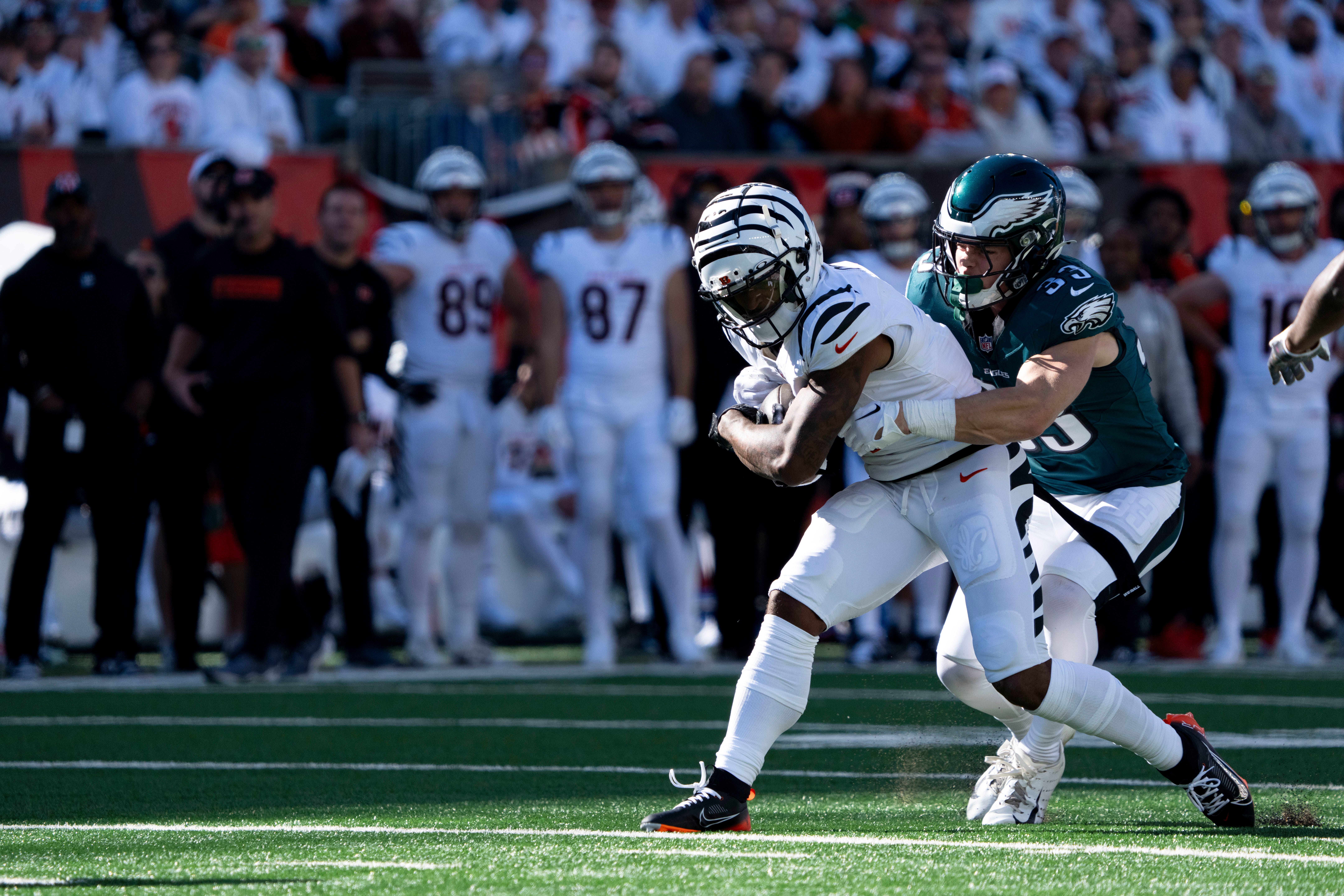 Philadelphia Eagles defensive back Cooper DeJean (33) tackles Cincinnati Bengals wide receiver Ja'Marr Chase (1) after making a first down catch in the third quarter of the NFL game at Paycor Stadium.