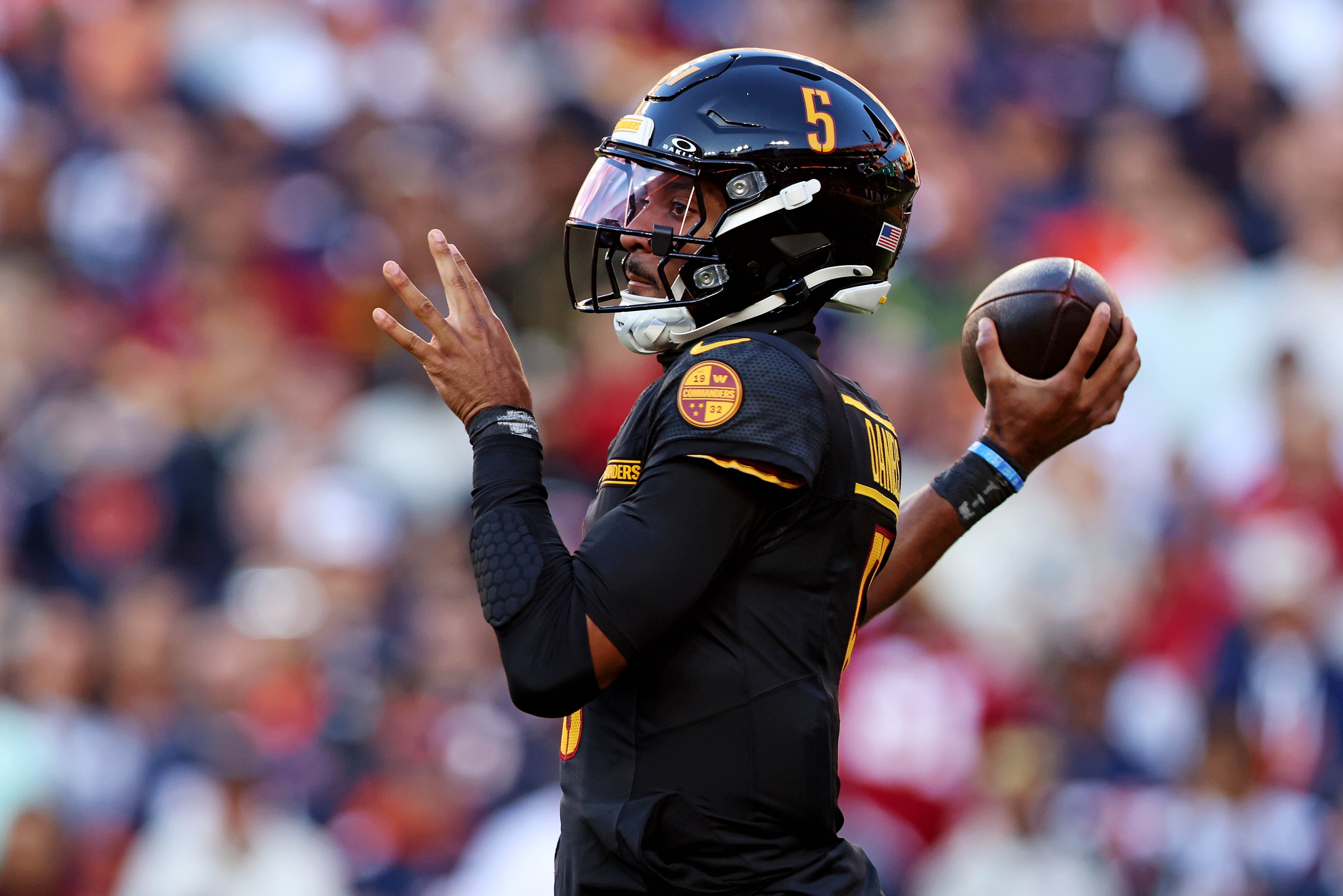 Oct 27, 2024; Landover, Maryland, USA; Washington Commanders quarterback Jayden Daniels (5) throws a pass during the first quarter against the Chicago Bears at Commanders Field.