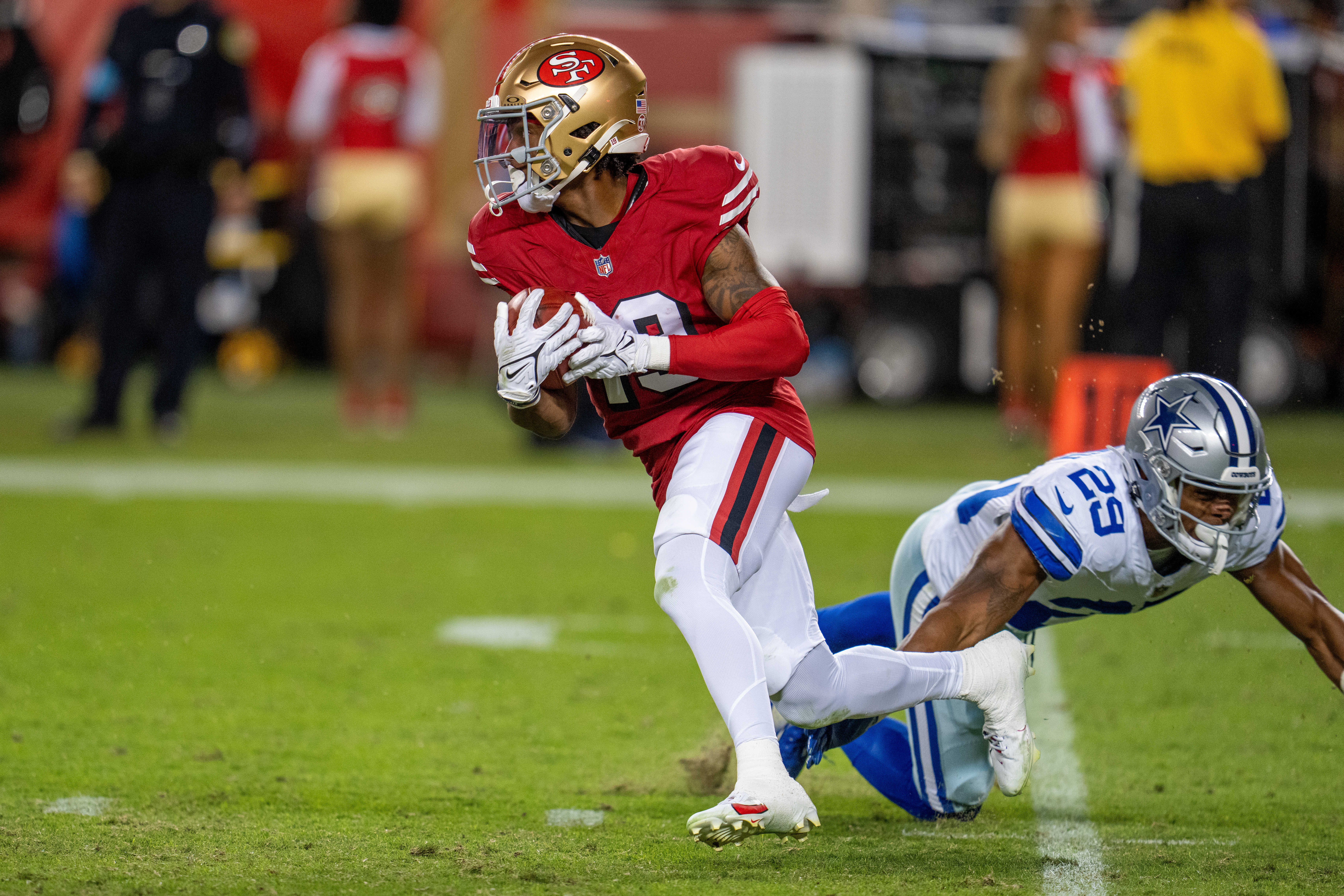 San Francisco 49ers wide receiver Jacob Cowing (19) on a runback against Dallas Cowboys cornerback C.J. Goodwin (29) at Levi's Stadium.