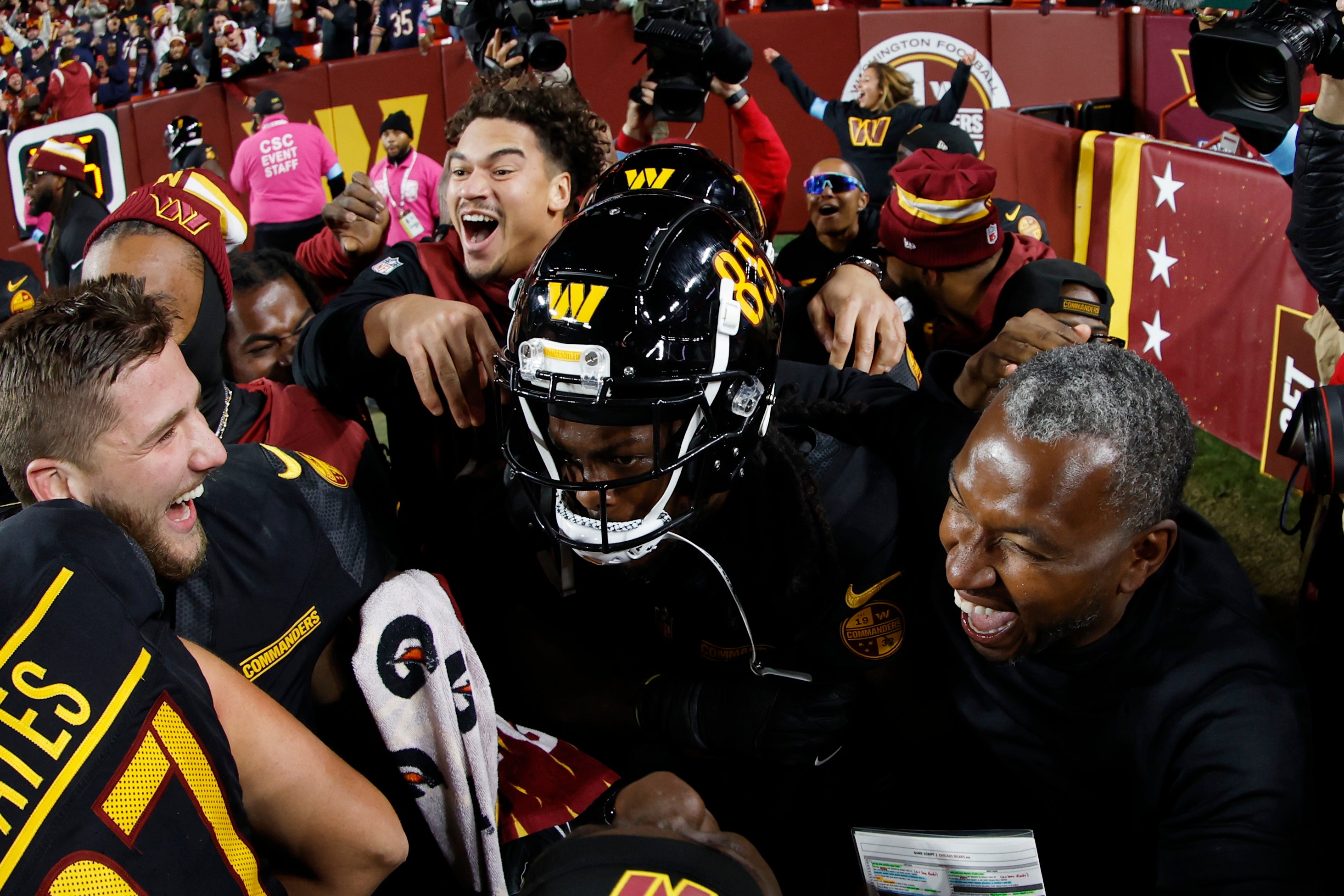 Oct 27, 2024; Landover, Maryland, USA; Washington Commanders wide receiver Noah Brown (85) celebrates with teammates after catching a game-winnning Hail Mary pass on the final play of the game against the Chicago Bears at Northwest Stadium.