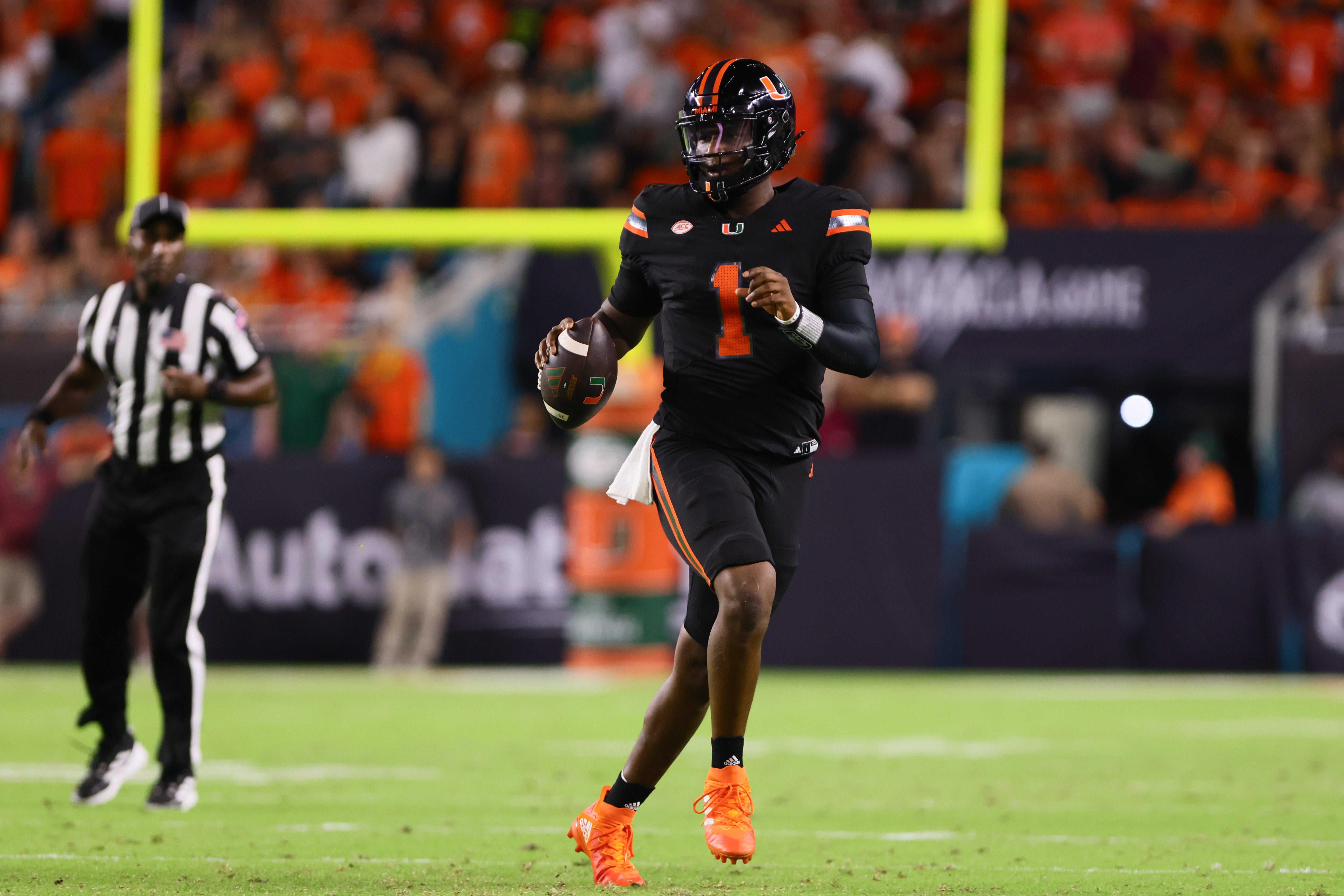 Oct 26, 2024; Miami Gardens, Florida, USA; Miami Hurricanes quarterback Cam Ward (1) runs with the football against the Florida State Seminoles during the second quarter at Hard Rock Stadium.