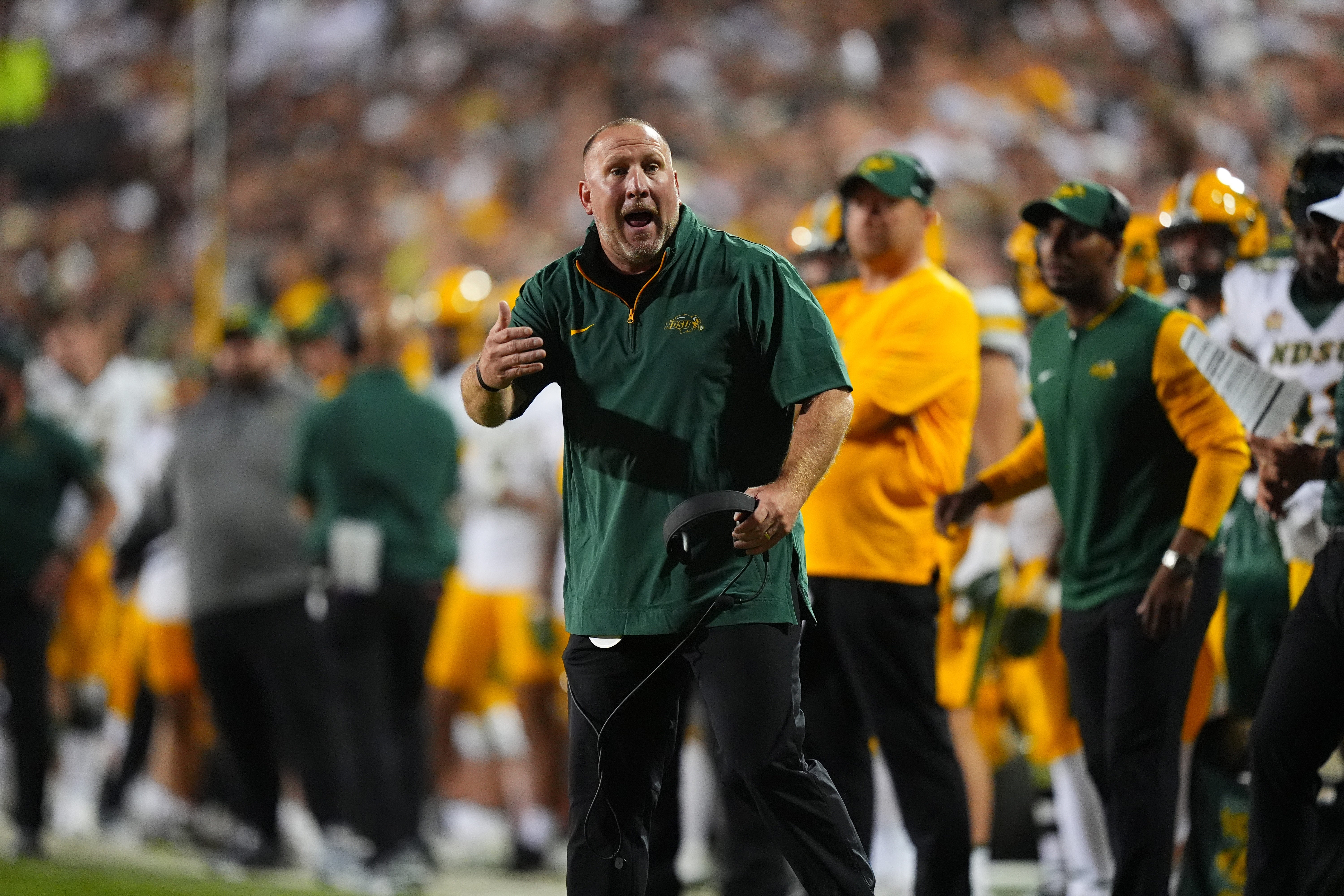 North Dakota State Bison head coach Tim Polasek calls out in the second half against the Colorado Buffaloes at Folsom Field.