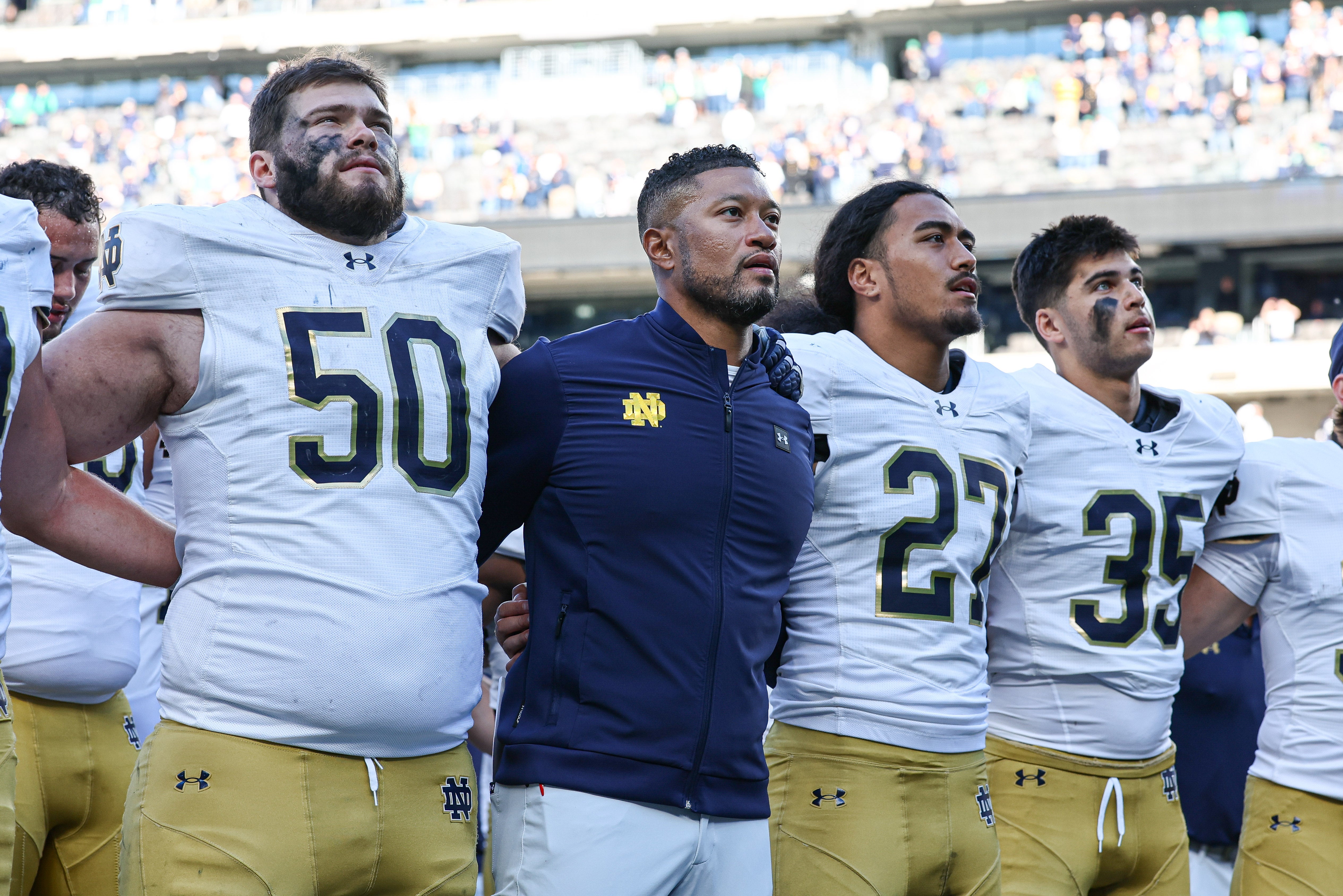 Notre Dame Fighting Irish head coach Marcus Freeman sings the Notre Dame alma mater with teammates after the game against the Navy Midshipmen at MetLife Stadium.