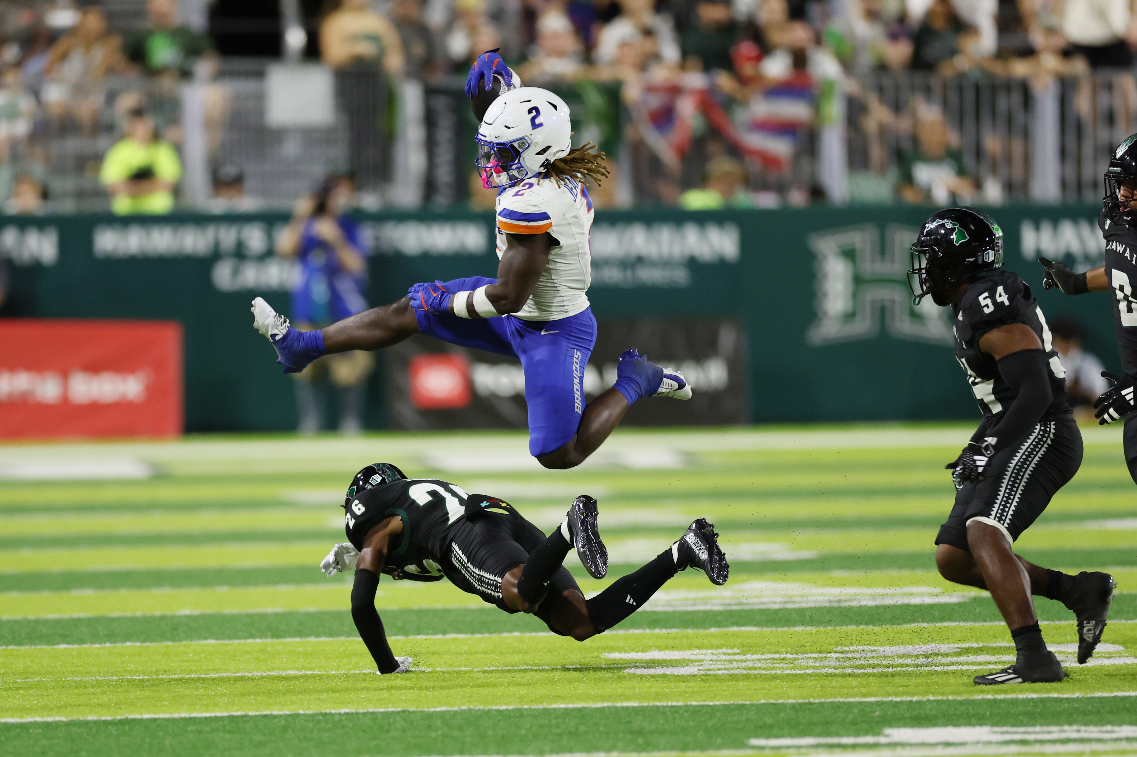 Oct 12, 2024; Honolulu, Hawaii, USA; Boise State Broncos running back Ashton Jeanty (2) leaps over Hawaii Rainbow Warriors defensive back Deliyon Freeman (26) during the second quarter at Clarence T.C. Ching Athletics Complex. The play was called back due to a Broncos foul.