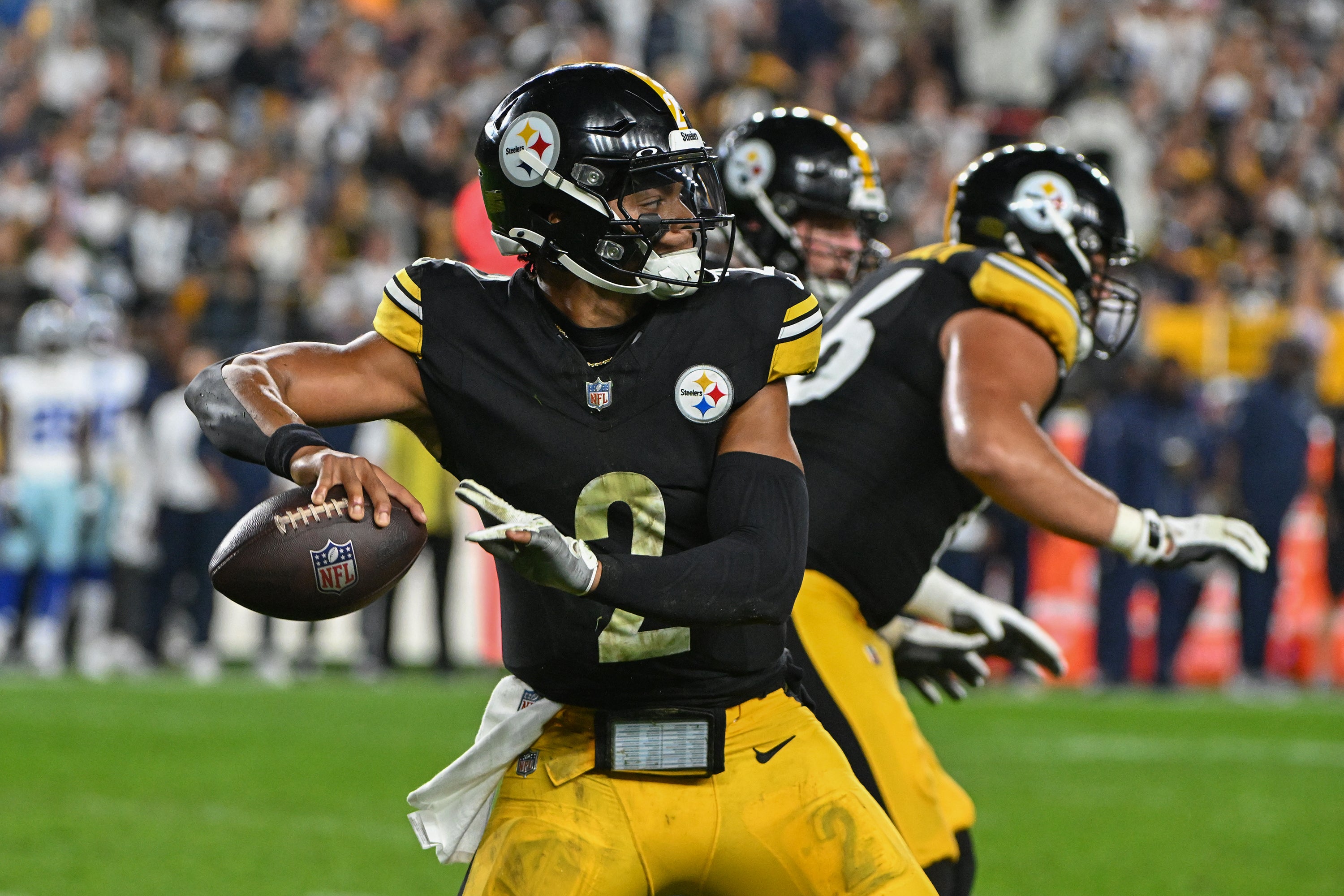 Oct 6, 2024; Pittsburgh, Pennsylvania, USA; Pittsburgh Steelers quarterback Justin Fields (2) throws a pass against the Dallas Cowboys during the first quarter at Acrisure Stadium.