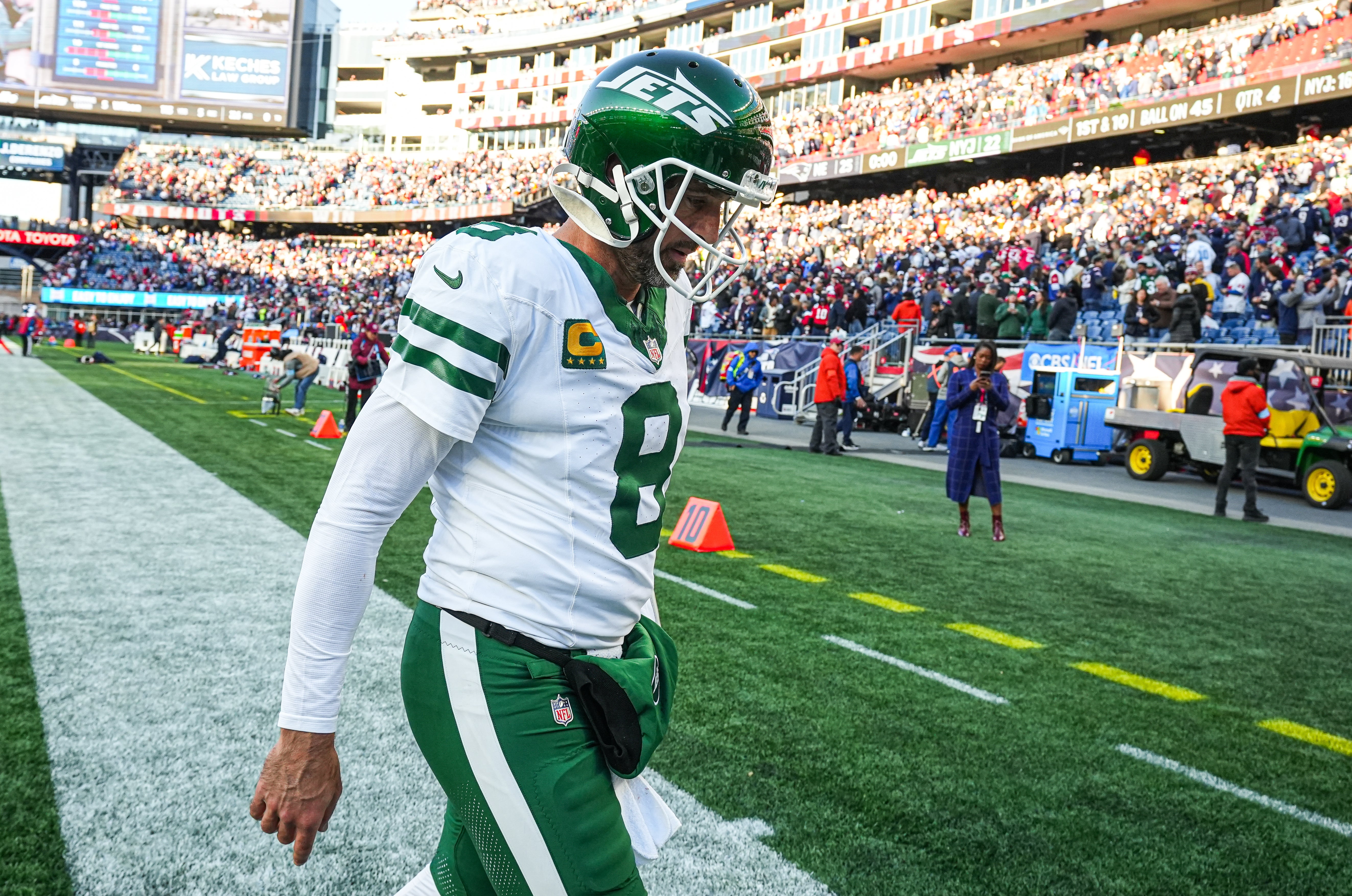 New York Jets quarterback Aaron Rodgers (8) exits the field after being defeated by the New England Patriots in the second half at Gillette Stadium.