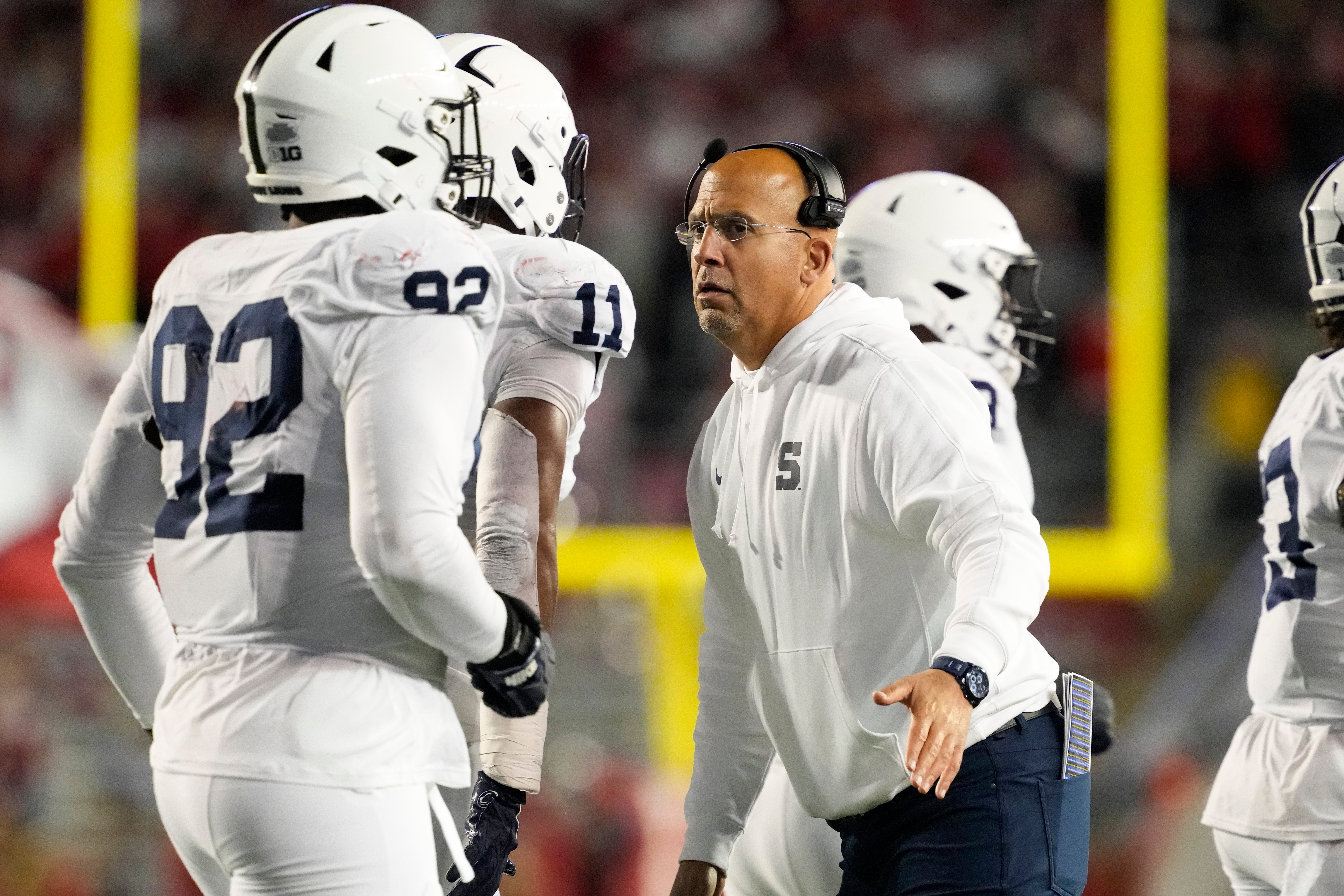 Penn State Nittany Lions head coach James Franklin greets players following a play during the second quarter against the Wisconsin Badgers at Camp Randall Stadium.
