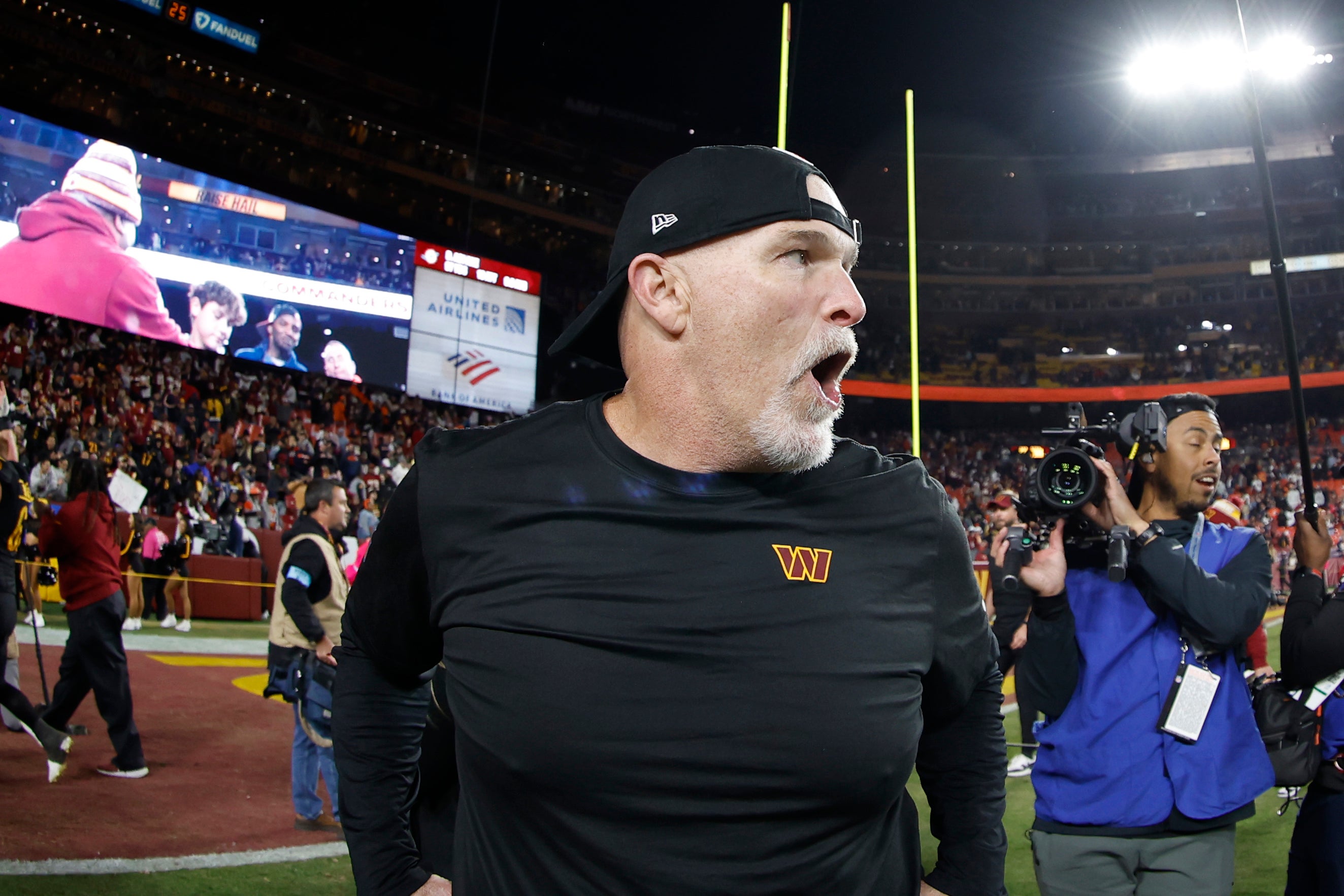 Oct 27, 2024; Landover, Maryland, USA;Washington Commanders head coach Dan Quinn celebrates while leaving the field after the Commanders' game against the Chicago Bears at Northwest Stadium.